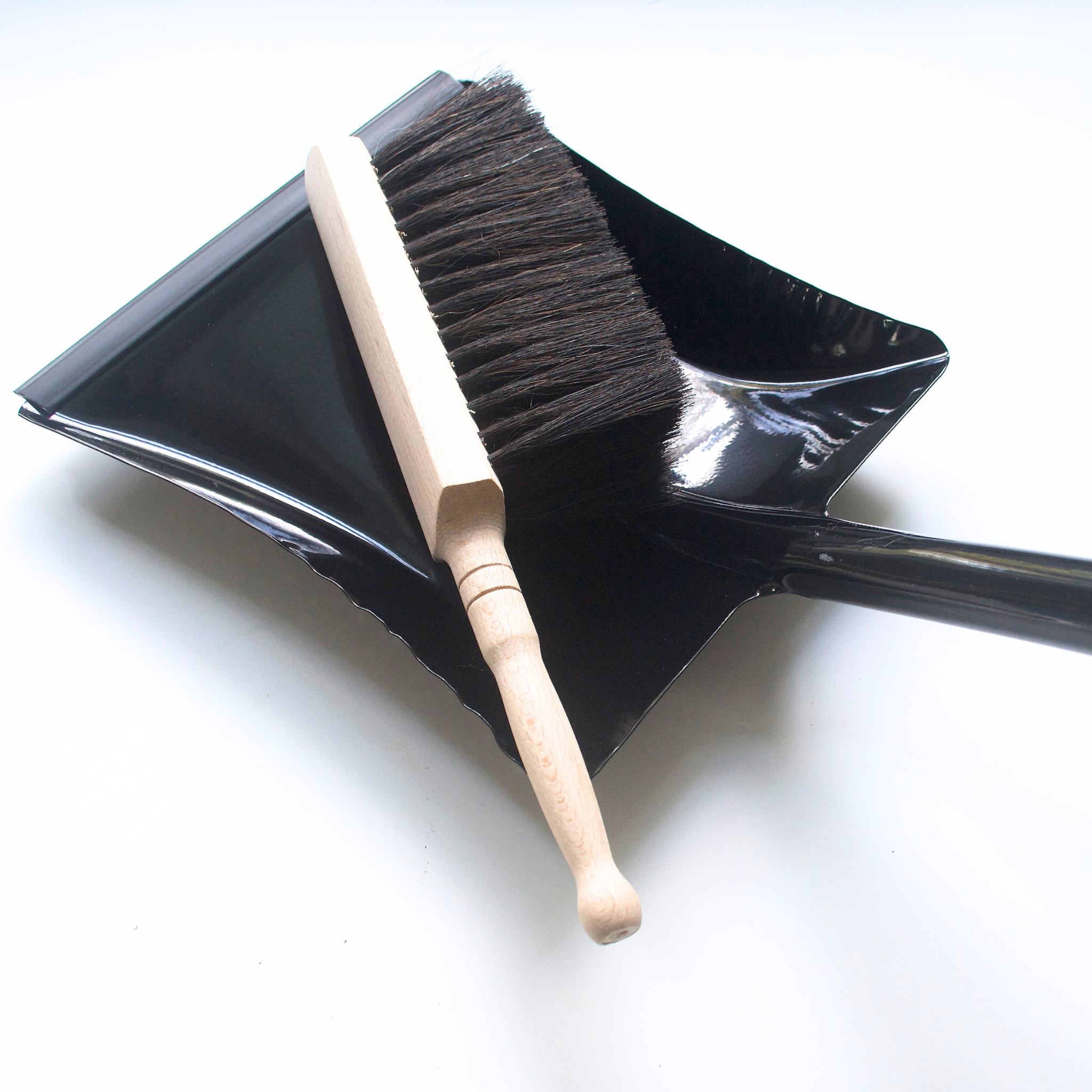 Heaven in Earth (HIE) German-made metal dustpan, available in black or white, featuring a sleek, durable design with a comfortable handle, perfect for quick and efficient cleanup while adding a modern, minimalist touch to your cleaning tools