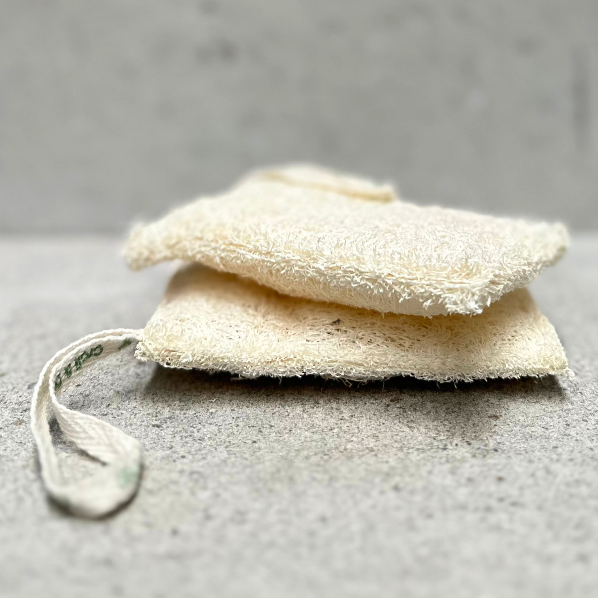 Pack of two natural loofah kitchen sponges made from plant fibres with plastic-free packaging by Croll & Denecke Germany.