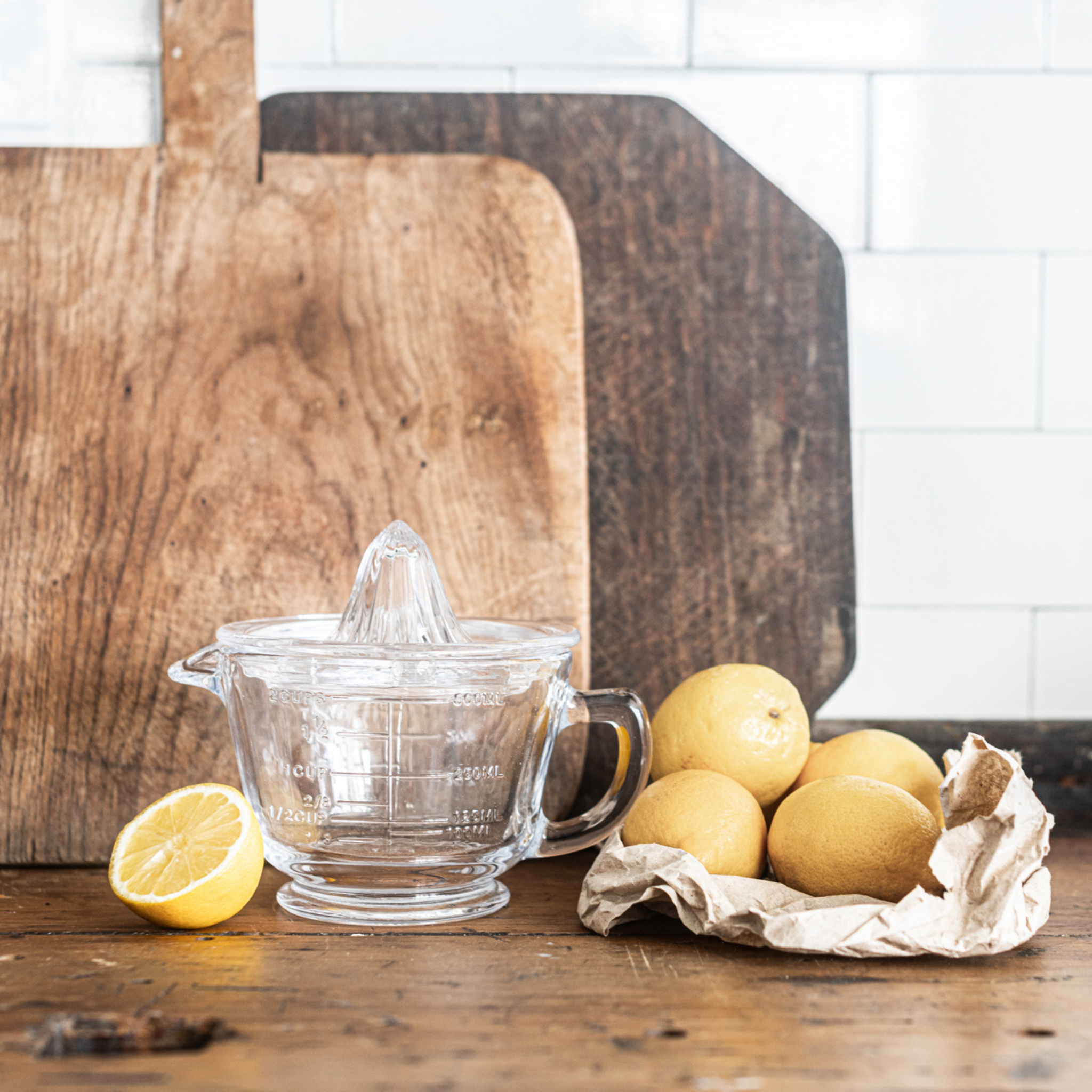 Glass citrus juicer and measuring jug, designed for effortless juicing with a built-in pour spout and measurement markings, perfect for squeezing and serving fresh juice. Heaven In Earth