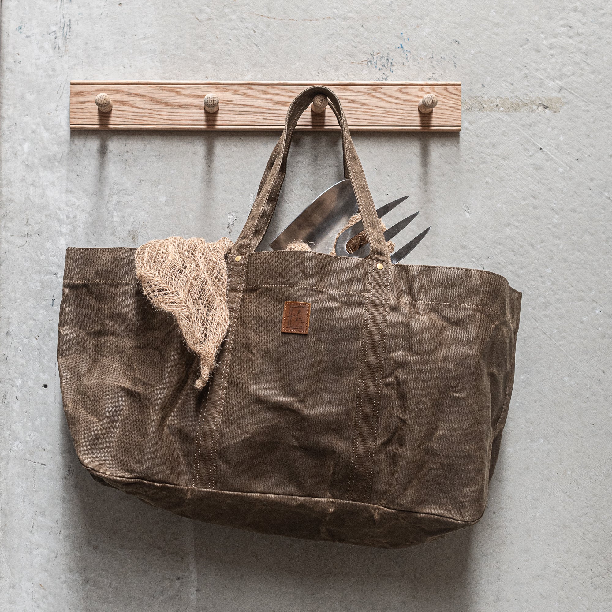 Durable Waxed Canvas Carry All by Heaven in Earth, designed for everyday use with a rugged, water-resistant waxed canvas construction. This versatile bag features sturdy handles and a spacious interior, perfect for carrying everything from groceries to gym gear, offering both style and practicality for on-the-go living.