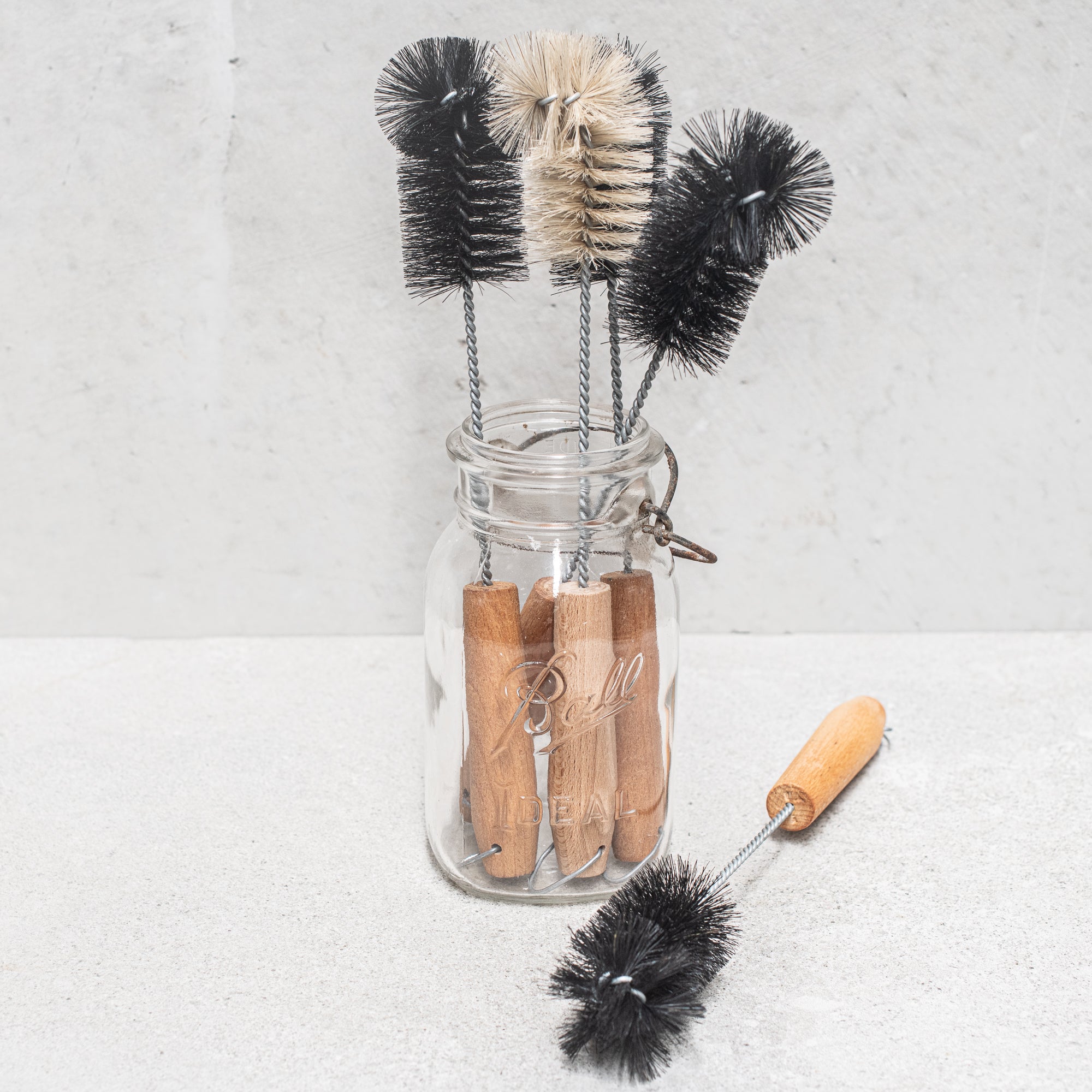 German-made bottle brush with natural fibre bristles light and dark, and a sturdy wooden handle, designed for thorough cleaning of bottles and jars, offering durability and eco-friendly craftsmanship