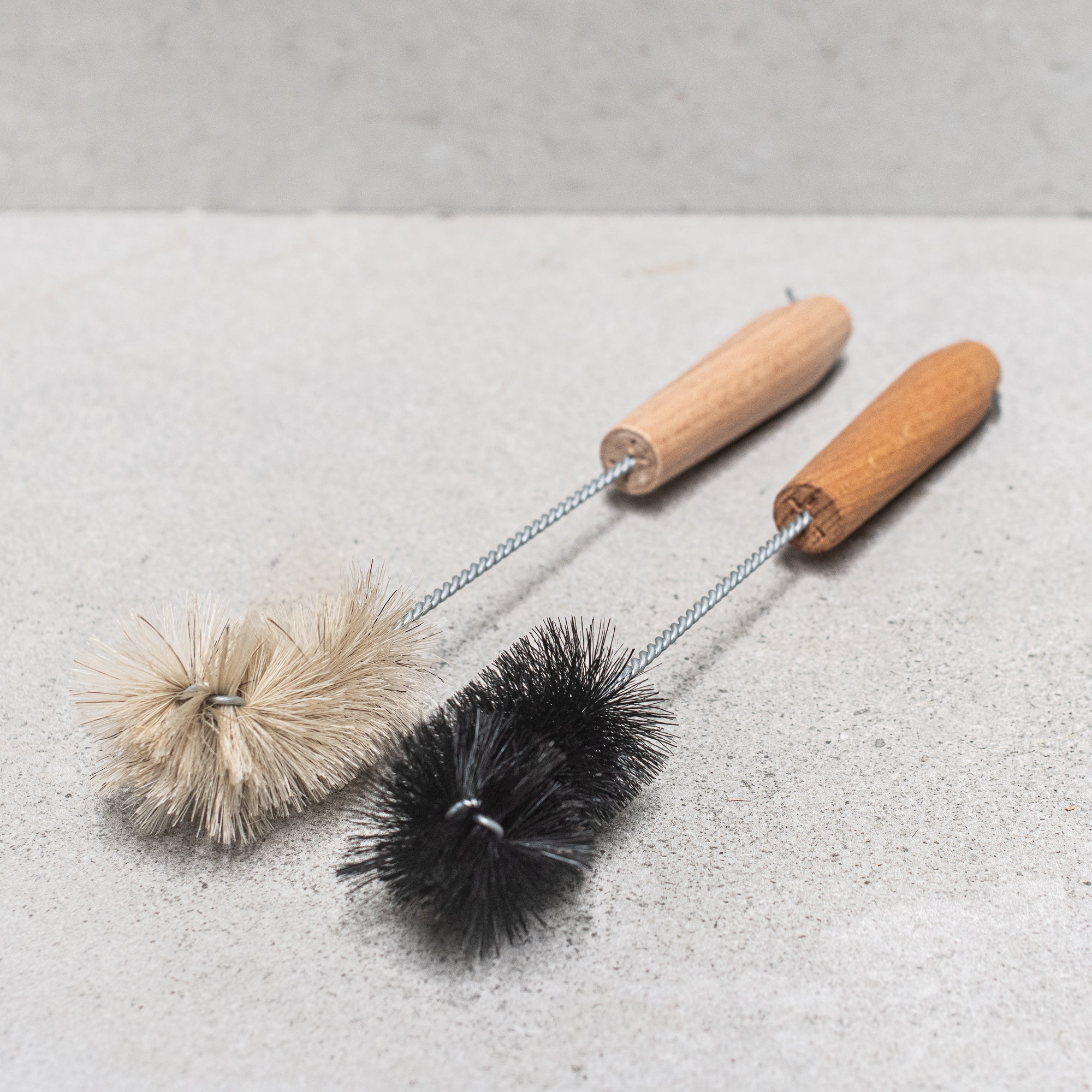 German-made bottle brush with natural fibre bristles light and dark, and a sturdy wooden handle, designed for thorough cleaning of bottles and jars, offering durability and eco-friendly craftsmanship