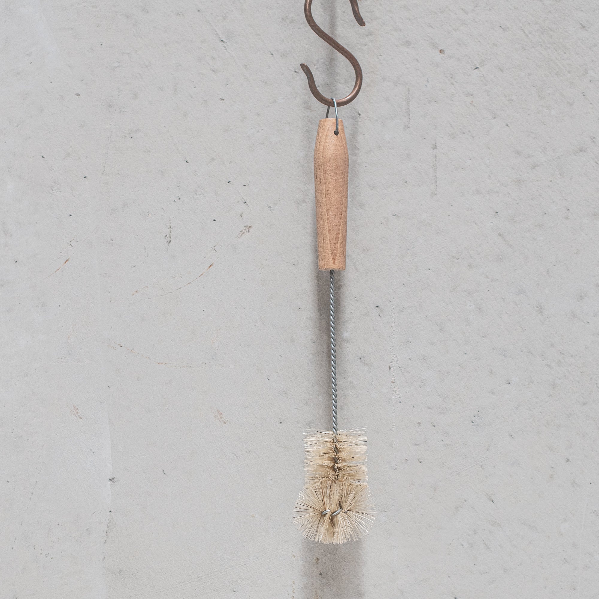 German-made bottle brush with natural fibre bristles light and dark, and a sturdy wooden handle, designed for thorough cleaning of bottles and jars, offering durability and eco-friendly craftsmanship