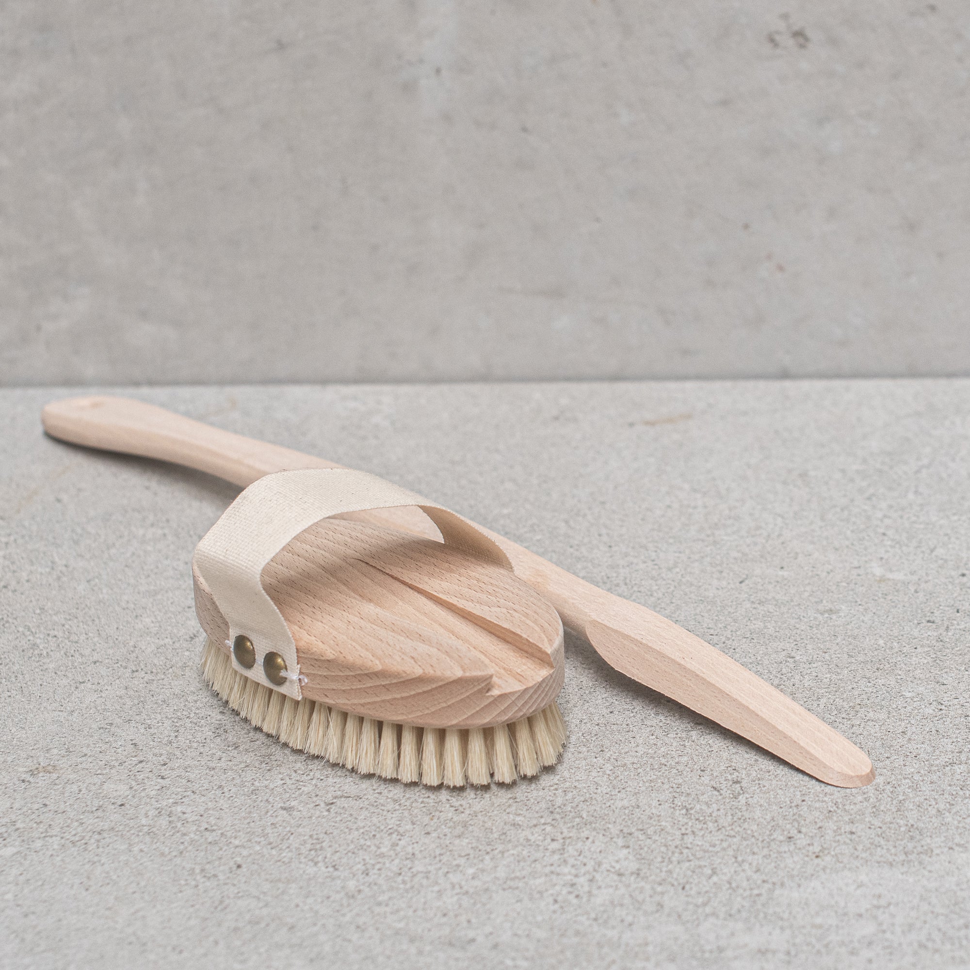 Natural bristle bath brush with a wooden handle, perfect for exfoliating and invigorating the skin during bath time