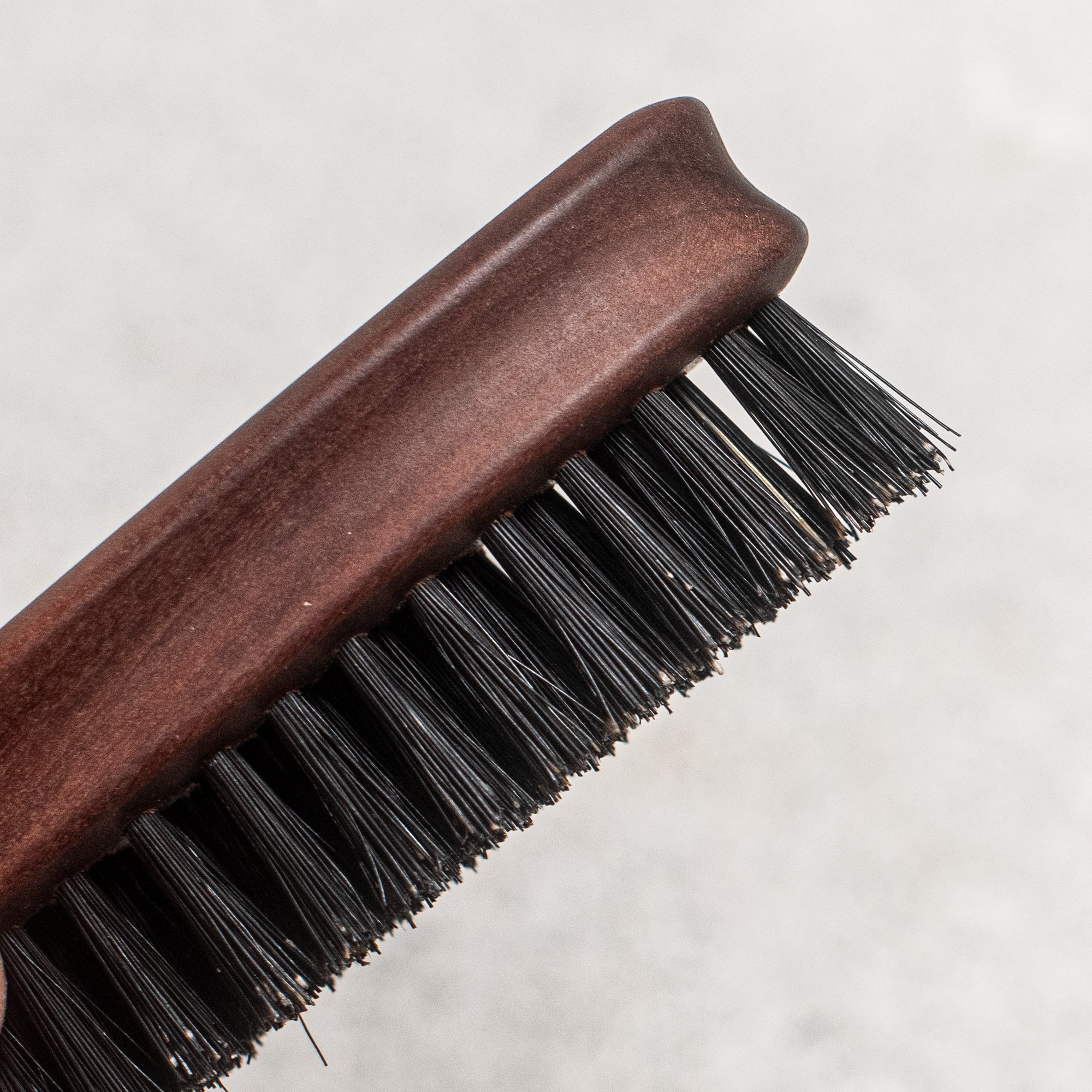 Fibre and timber beard brush with natural bristles and a wooden handle, designed to groom and tame facial hair while promoting a smooth, polished look
