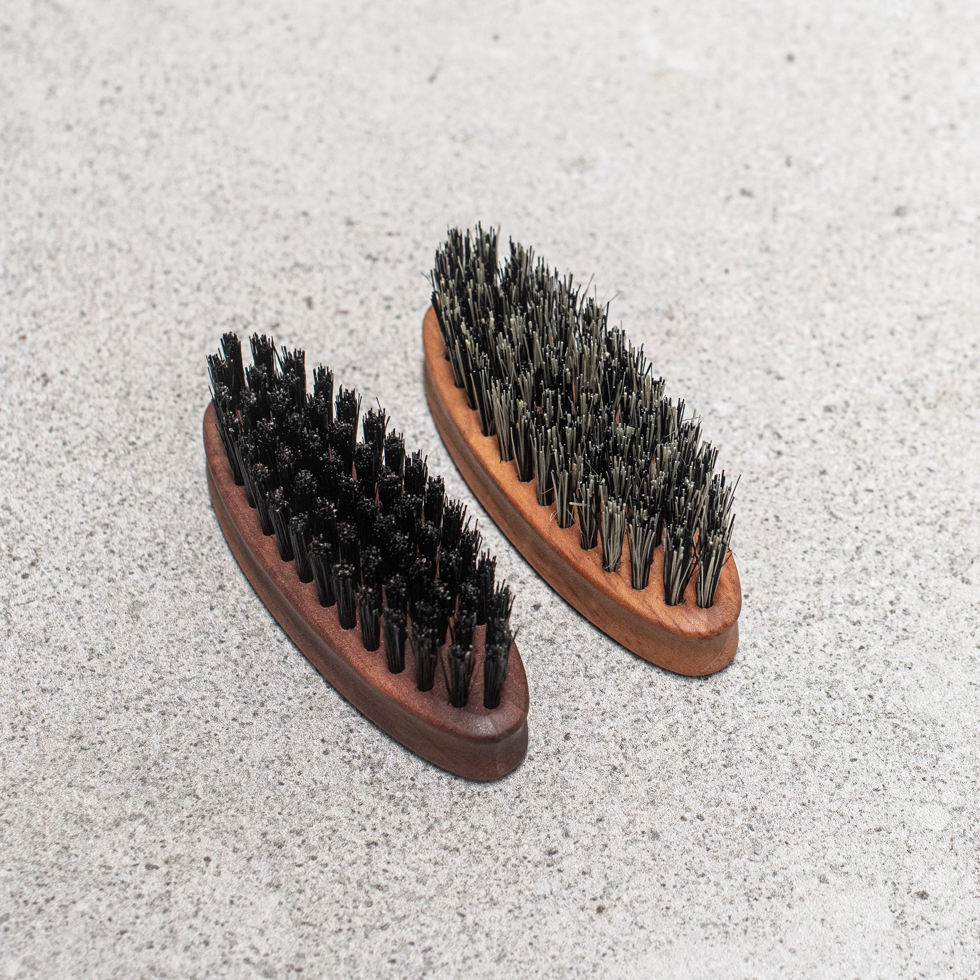 Fibre and timber beard brush with natural bristles and a wooden handle, designed to groom and tame facial hair while promoting a smooth, polished look