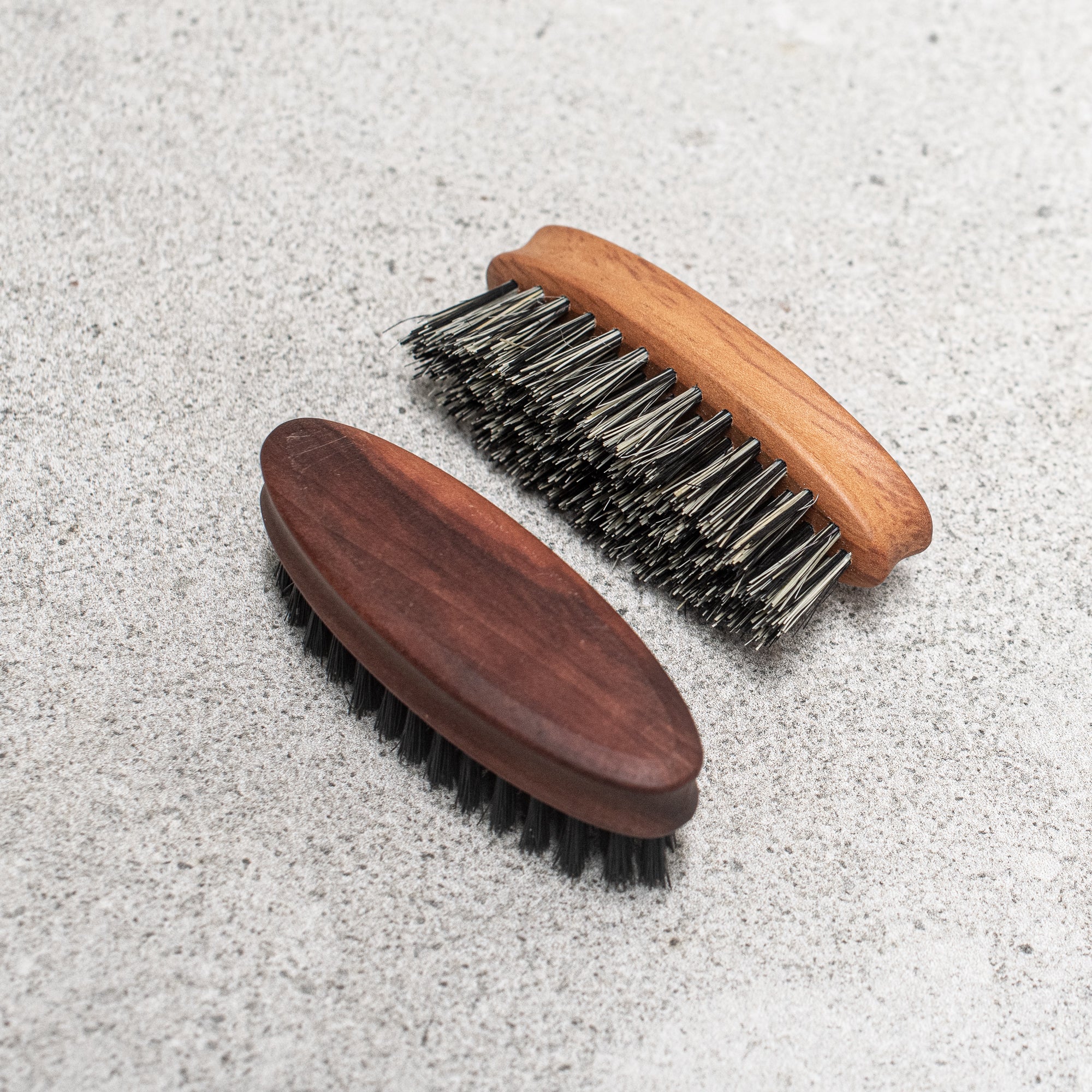 Fibre and timber beard brush with natural bristles and a wooden handle, designed to groom and tame facial hair while promoting a smooth, polished look