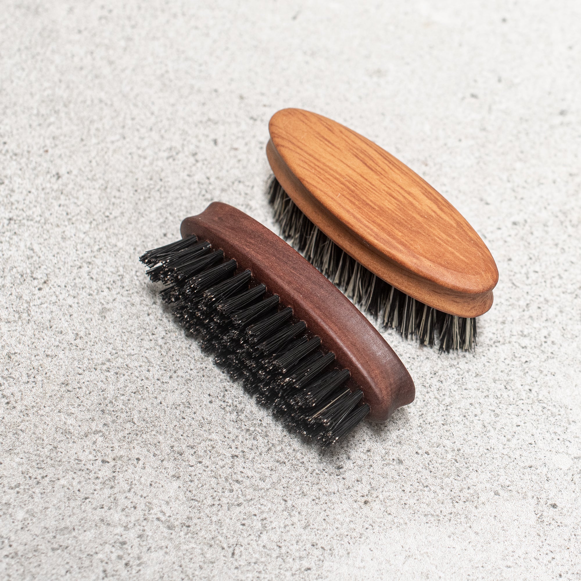 Fibre and timber beard brush with natural bristles and a wooden handle, designed to groom and tame facial hair while promoting a smooth, polished look