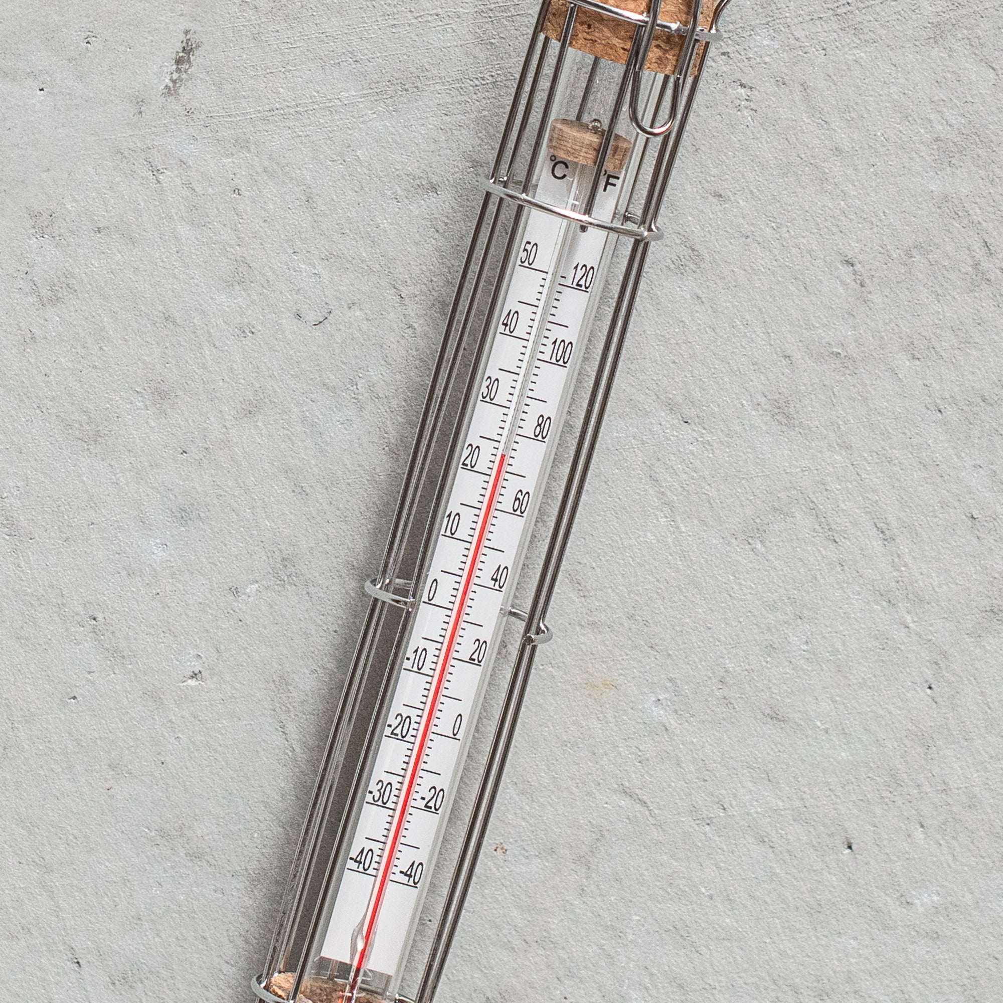 Stainless steel cage weather thermometer, featuring a sleek design with durable metal housing, ideal for measuring outdoor temperatures with accuracy and style.