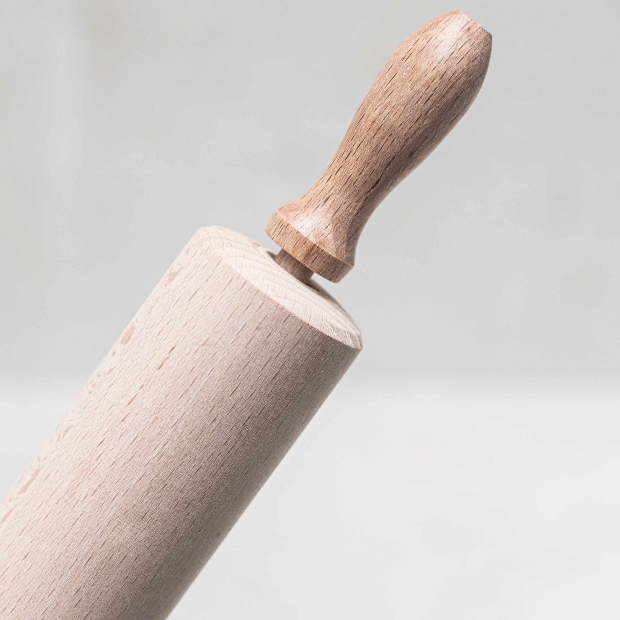 Children's wooden German-made cookset, crafted from durable, natural wood, featuring miniature kitchen tools like a spoon, whisk and tongs, designed for imaginative play and budding chefs.