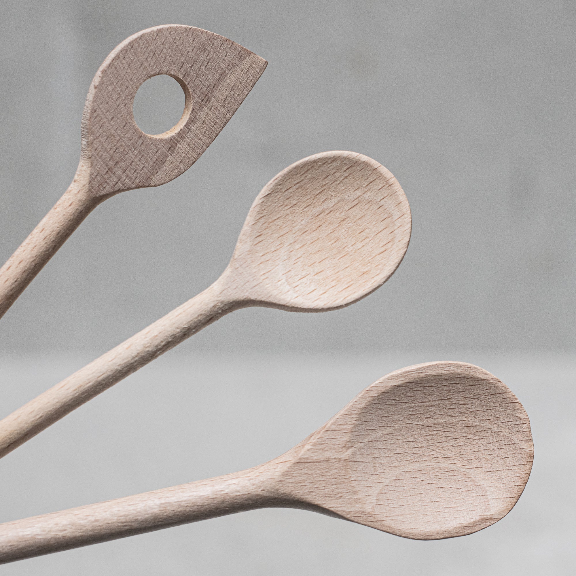 Children's wooden German-made cookset, crafted from durable, natural wood, featuring miniature kitchen tools like a spoon, whisk and tongs, designed for imaginative play and budding chefs.