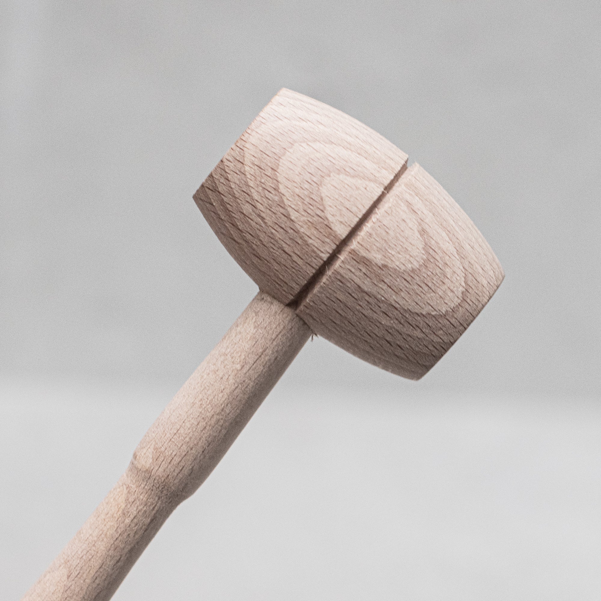 Children's wooden German-made cookset, crafted from durable, natural wood, featuring miniature kitchen tools like a spoon, whisk and tongs, designed for imaginative play and budding chefs.