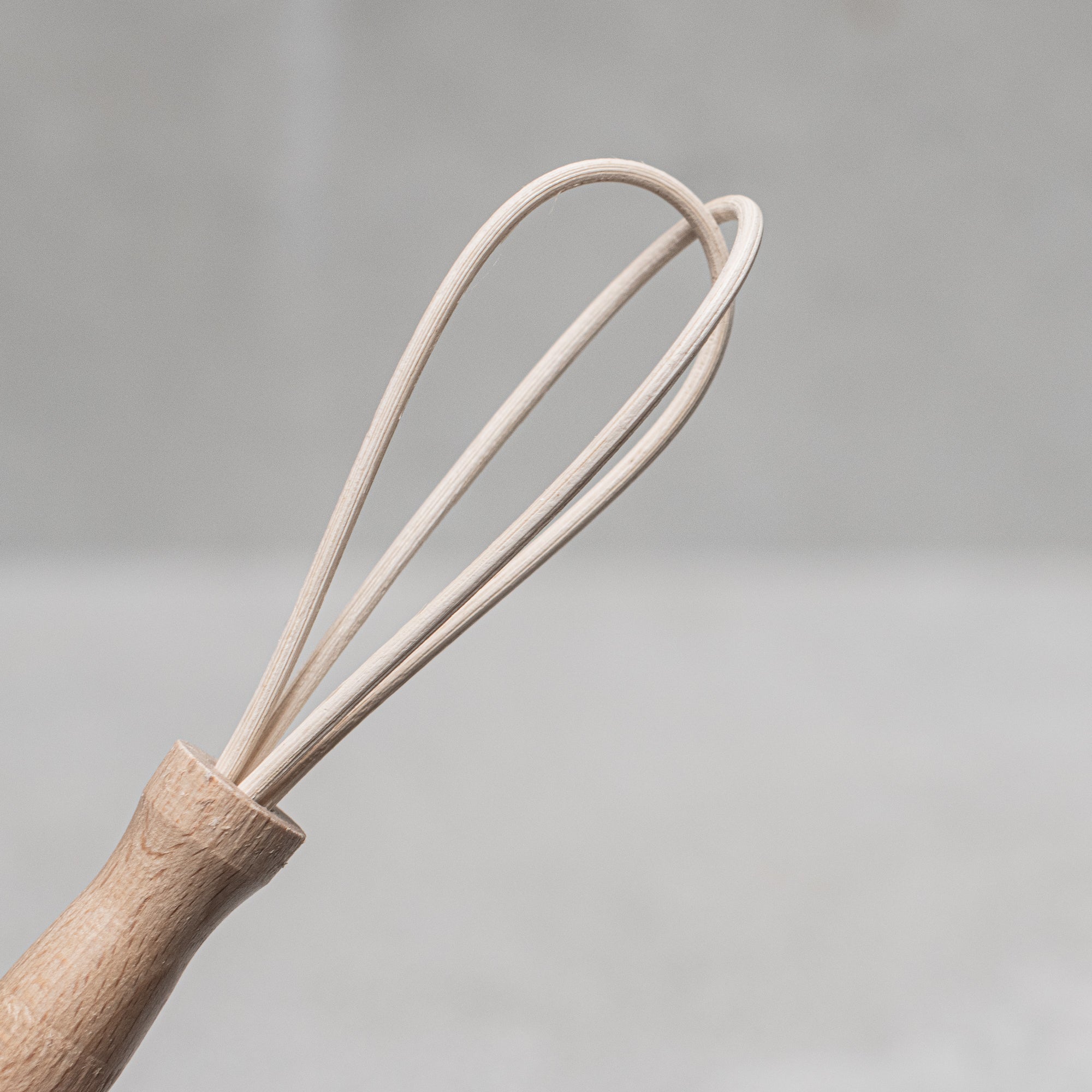 Children's wooden German-made cookset, crafted from durable, natural wood, featuring miniature kitchen tools like a spoon, whisk and tongs, designed for imaginative play and budding chefs.