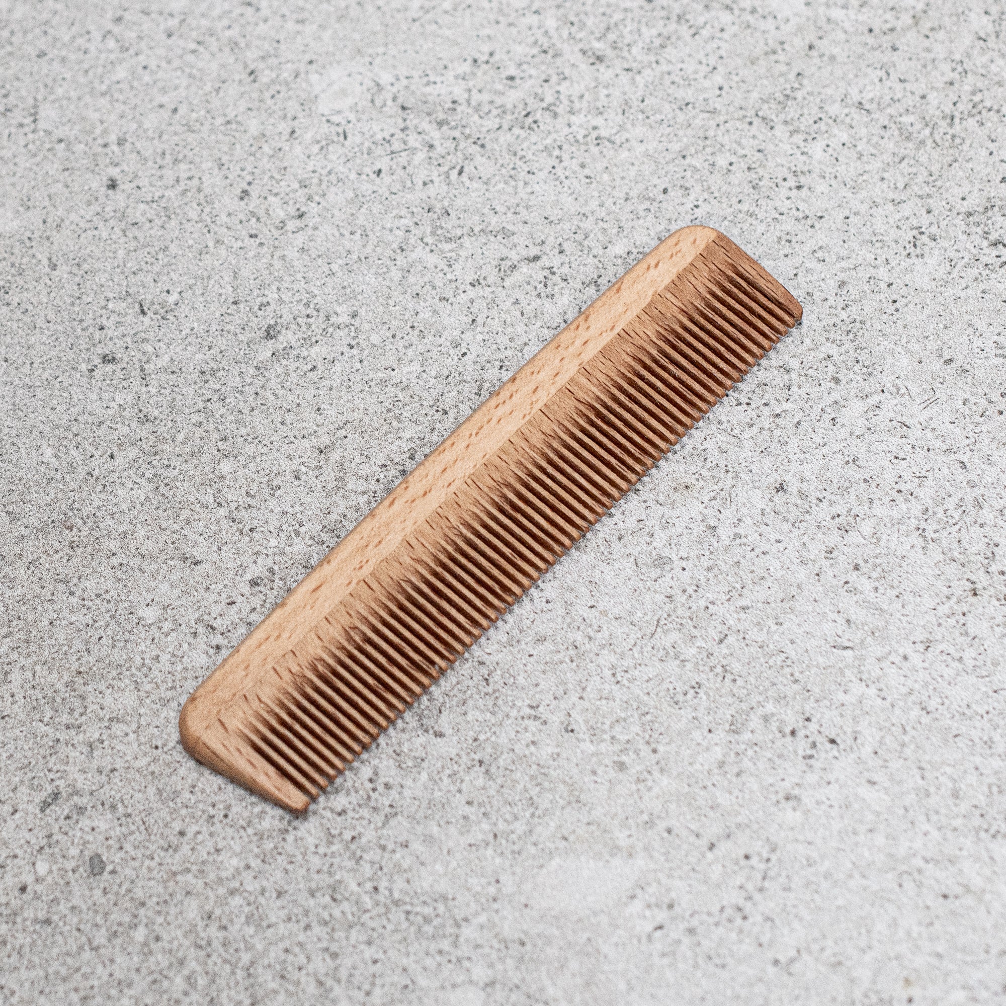aby wooden comb with smooth, rounded teeth, designed to gently detangle and care for delicate baby hair