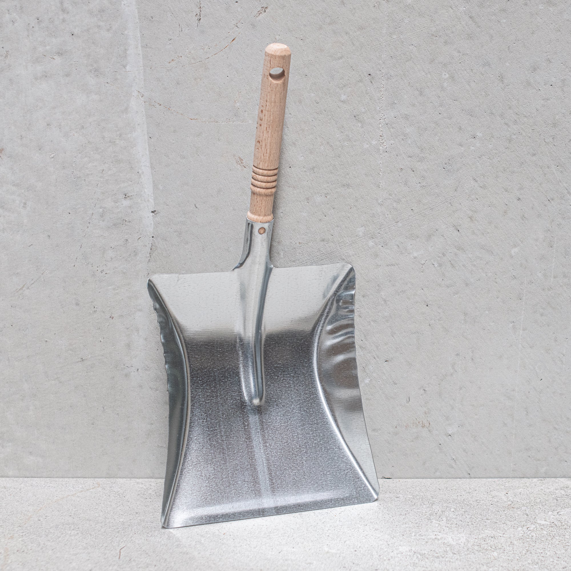 Heaven in Earth (HIE) German-made galvanized dustpan with a wooden handle, combining durable metal with a smooth wooden grip for easy sweeping and a timeless, rustic look
