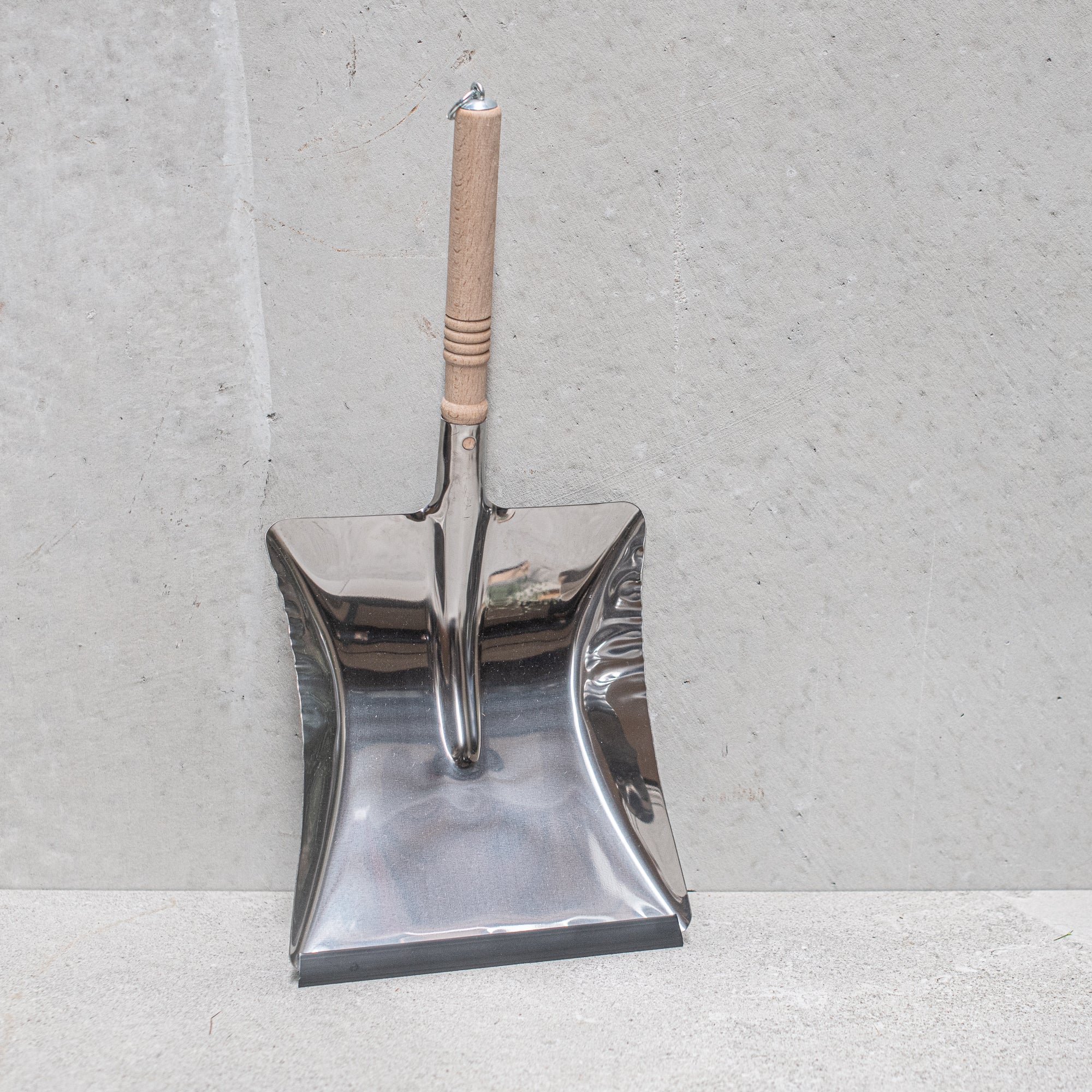 Heaven in Earth (HIE) stainless steel dustpan with wooden handle, made in Germany, combining durable stainless steel with a smooth wooden grip for a stylish, functional, and long-lasting cleaning tool