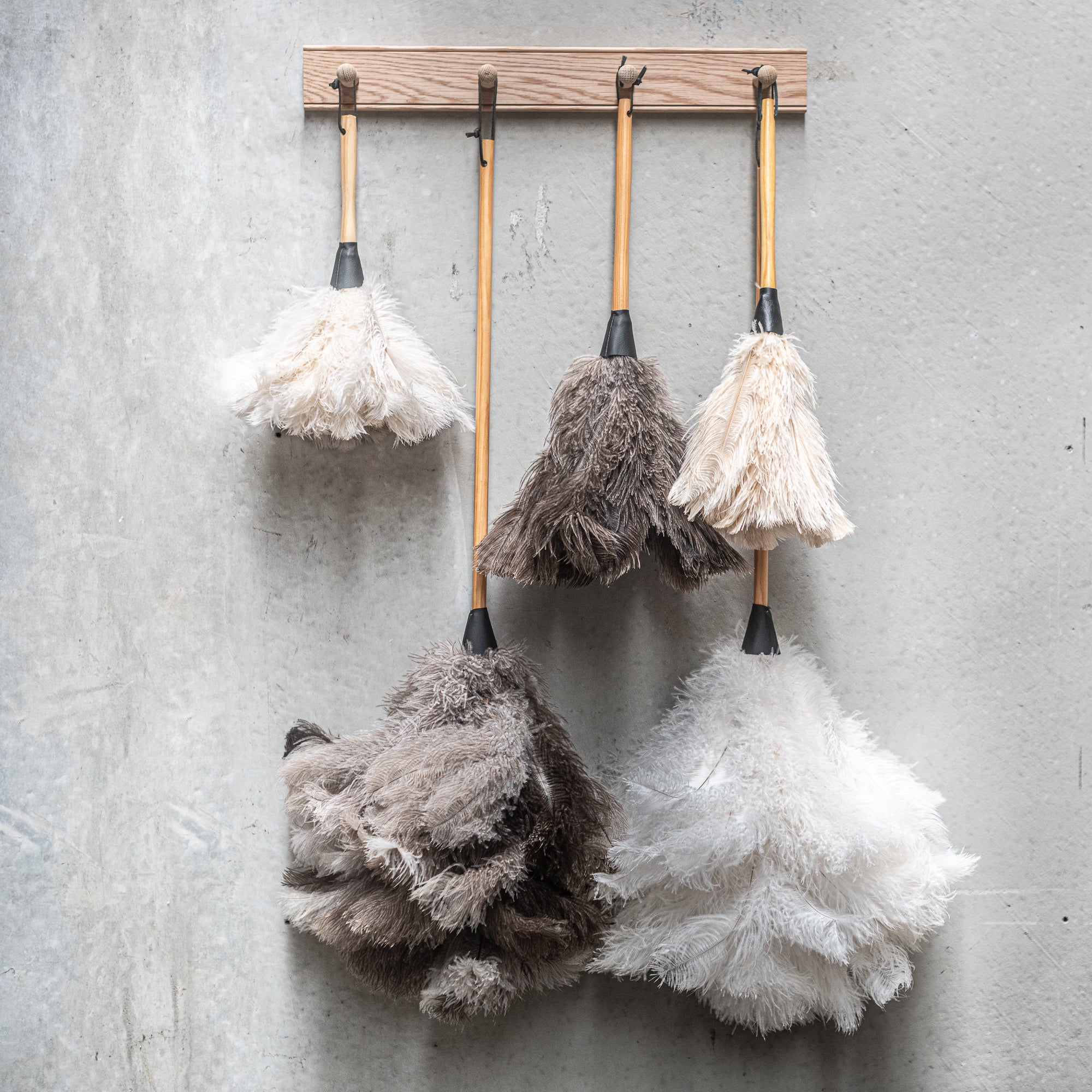 South African-made ostrich feather duster by Heaven in Earth (HIE), featuring soft, natural ostrich feathers that attract dust without spreading it. The lightweight wooden handle makes it easy to use, offering an elegant, eco-friendly solution for gentle, effective cleaning