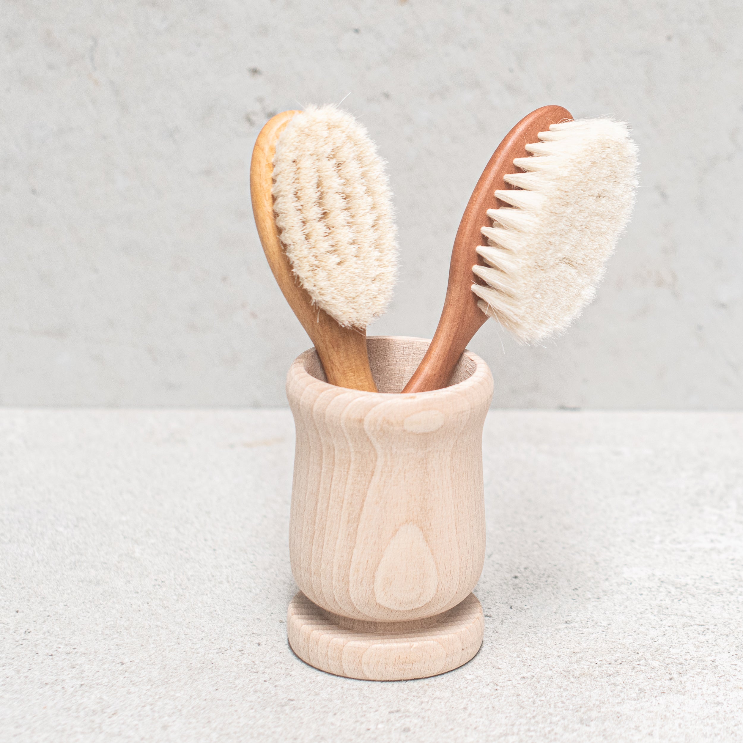 Soft goats hair baby brush with a gentle wooden handle, designed to care for delicate baby hair and sensitive scalps