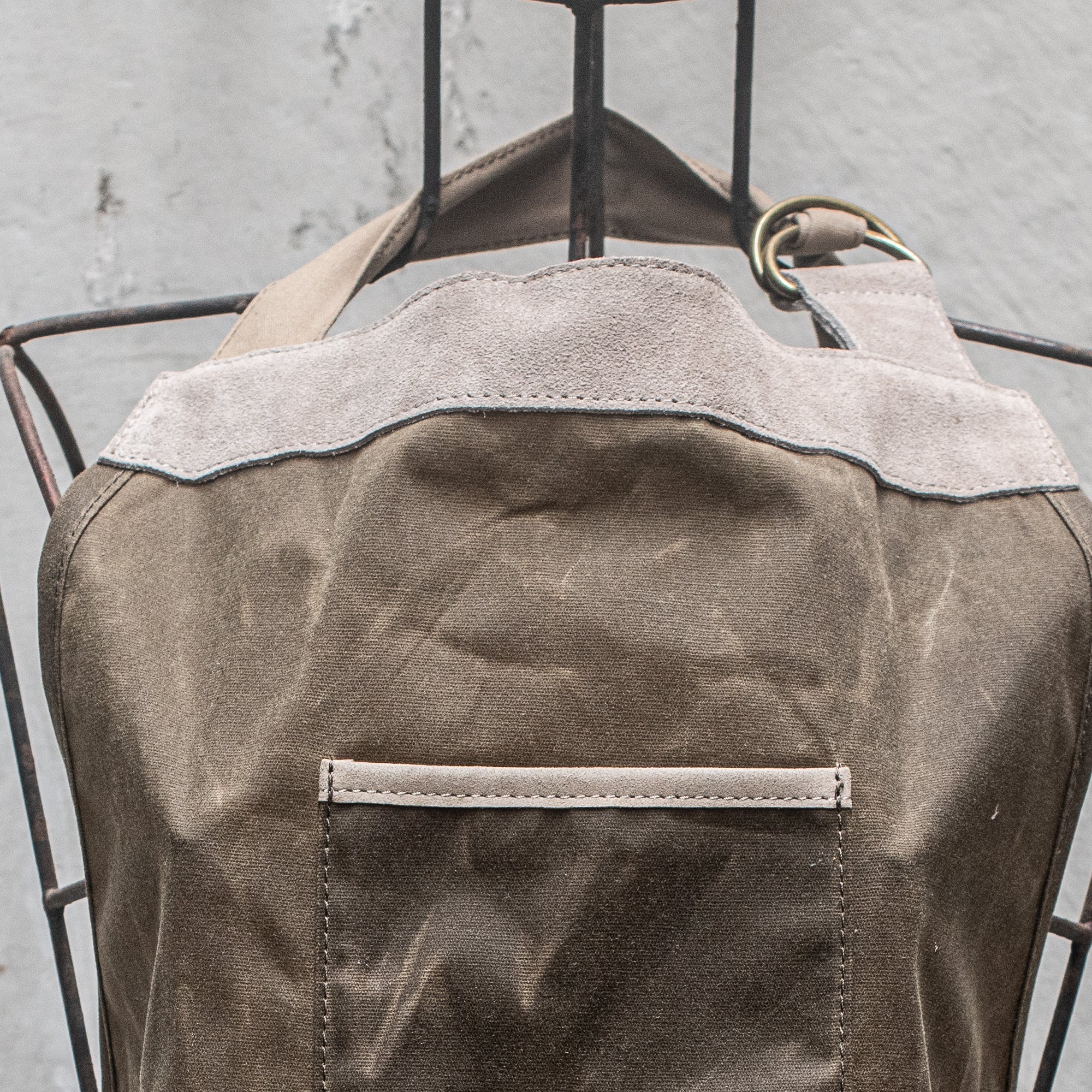 Waxed Canvas and Suede Apron by Heaven in Earth, designed for durability and style. Featuring a rugged waxed canvas body with soft suede accents, this apron is perfect for cooking, gardening, or crafting. Its adjustable straps and functional pockets make it as practical as it is fashionable, offering protection while adding a rustic, earthy touch to any task