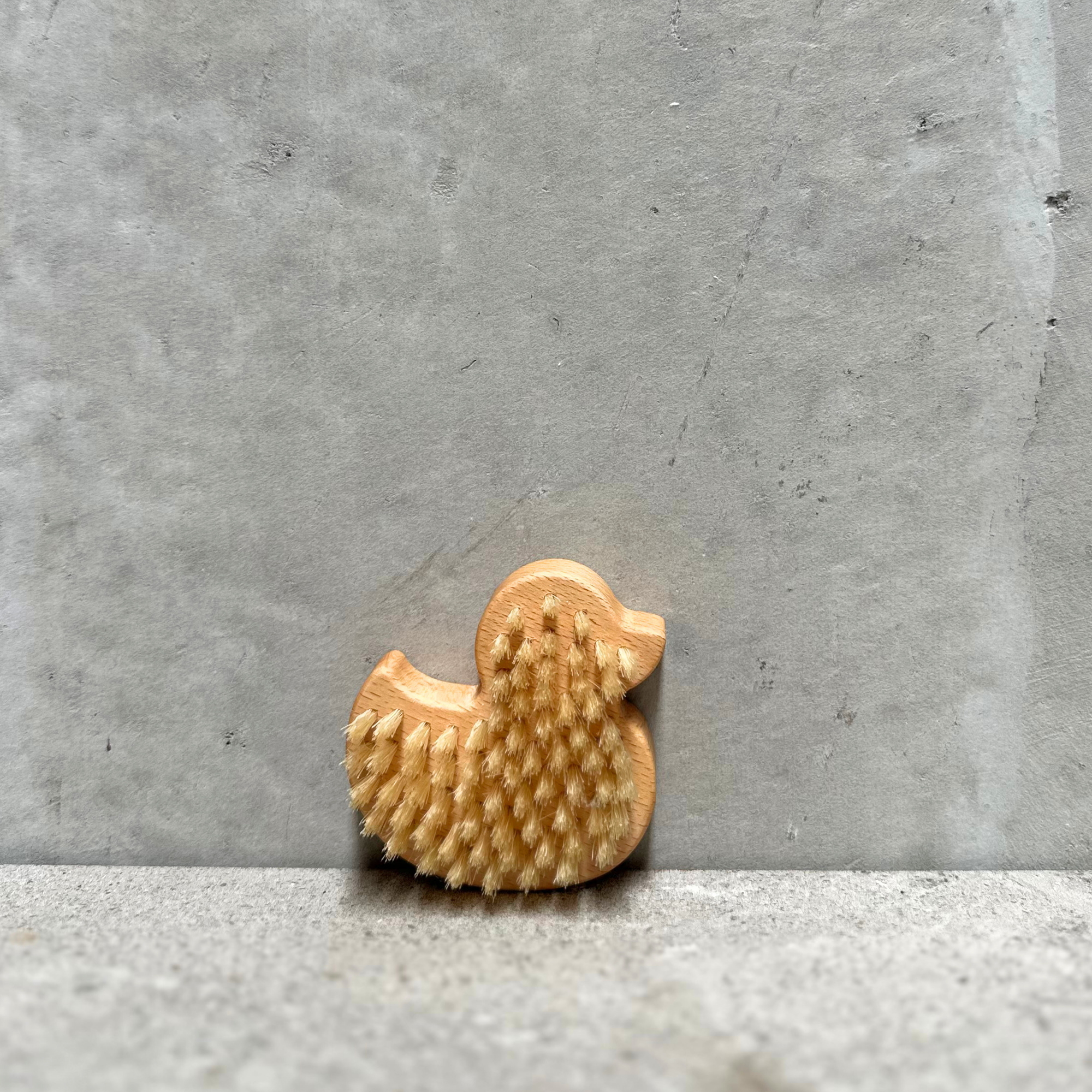 Back of handcrafted duck children's hand brush made from FSC-certified beechwood.