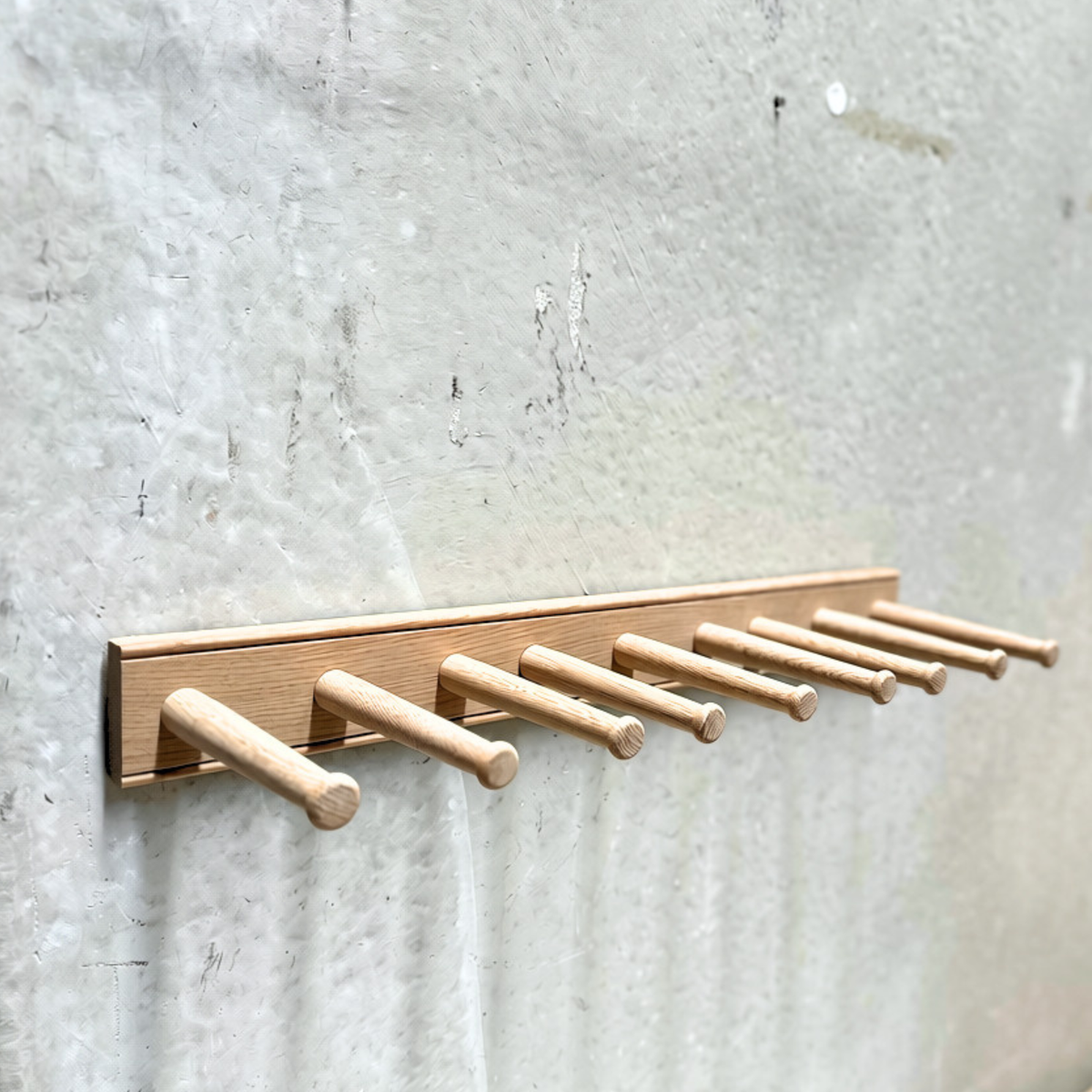 Natural oak wall-mounted boot rack holding up to three pairs of boots by Creamore Mill.