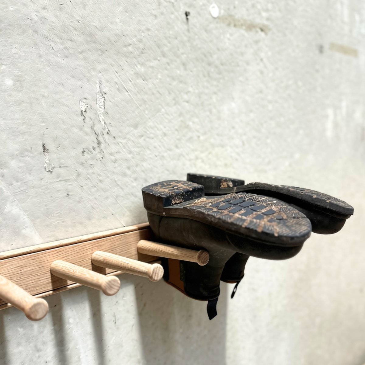 Natural oak wall-mounted boot rack holding up to three pairs of boots by Creamore Mill.
