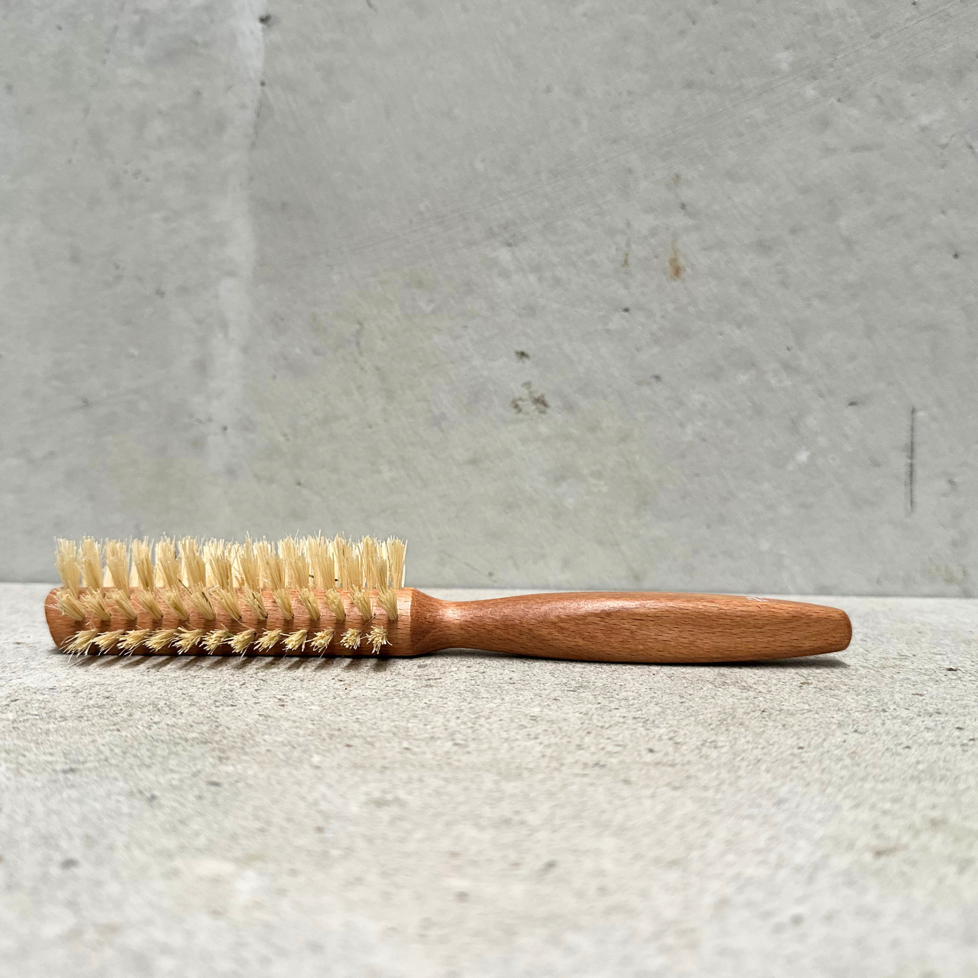 Half round vegan hair brush with beechwood handle and vegan fibre bristles by Faller Germany.