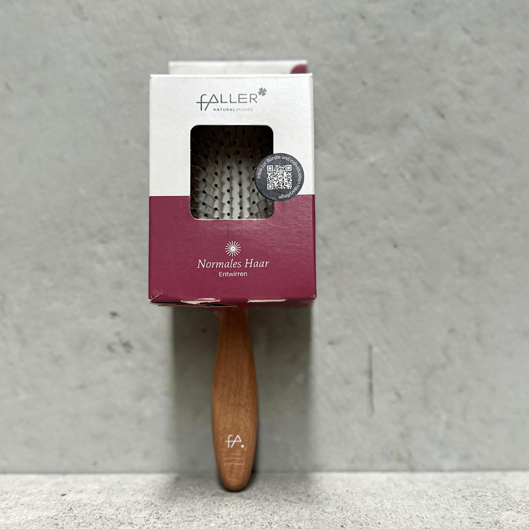 Oval vegan detangling hair brush with flexible rounded steel pins and beechwood handle for normal hair by Faller Germany.