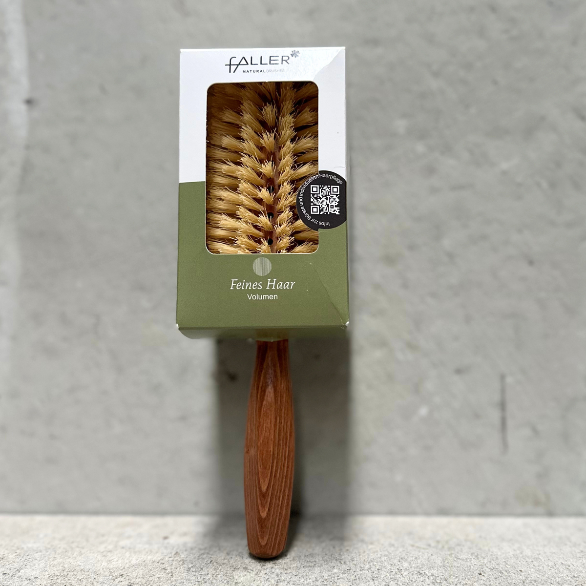 Round vegan hair brush with beechwood handle and vegan fibre bristles for fine hair by Faller Germany.
