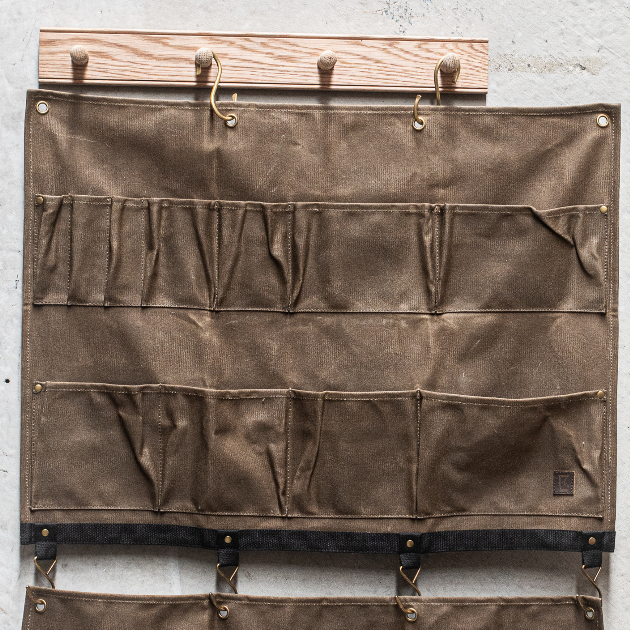 Durable Heaven in Earth waxed canvas hangers, designed for strength and style. Crafted from water-resistant waxed canvas, these hangers offer a sturdy, eco-friendly solution for all your organising needs combining functionality with a rugged, rustic aesthetic.