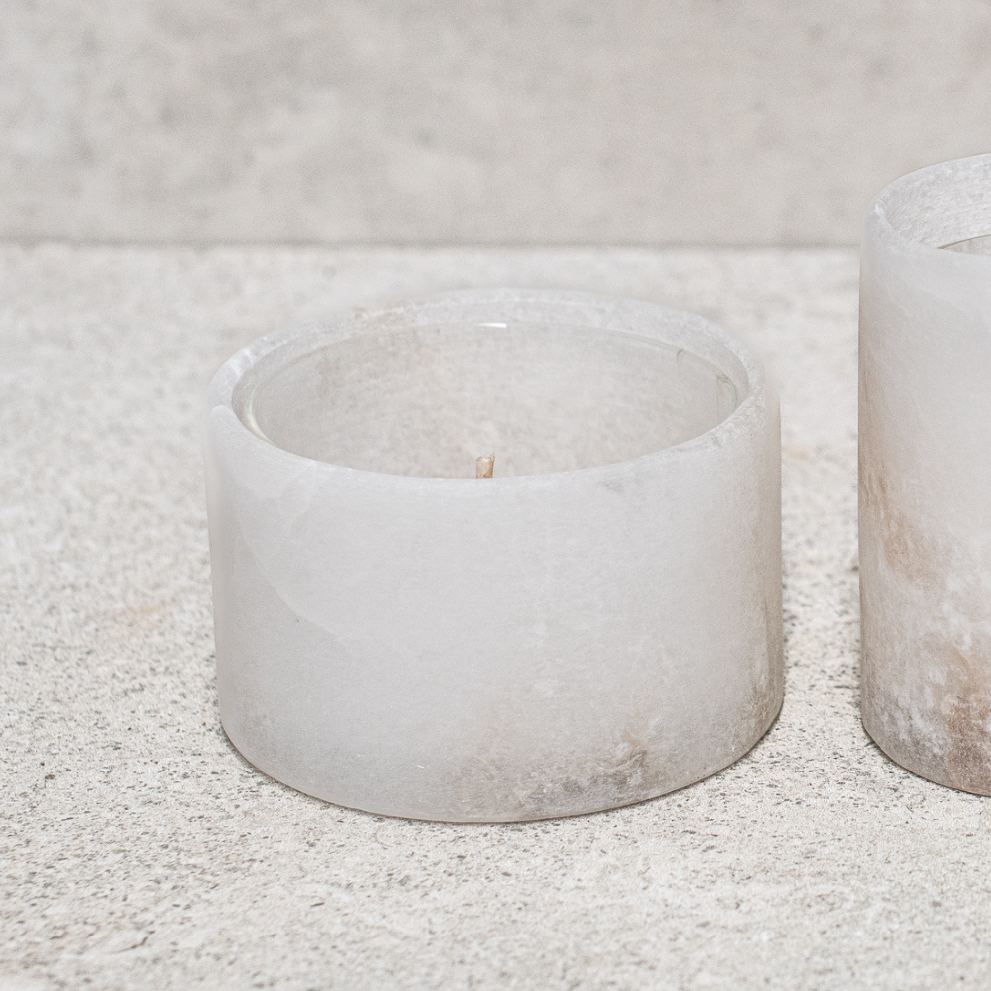 Set of alabaster votives, featuring a smooth, translucent design that gently diffuses light for a warm, ambient glow
