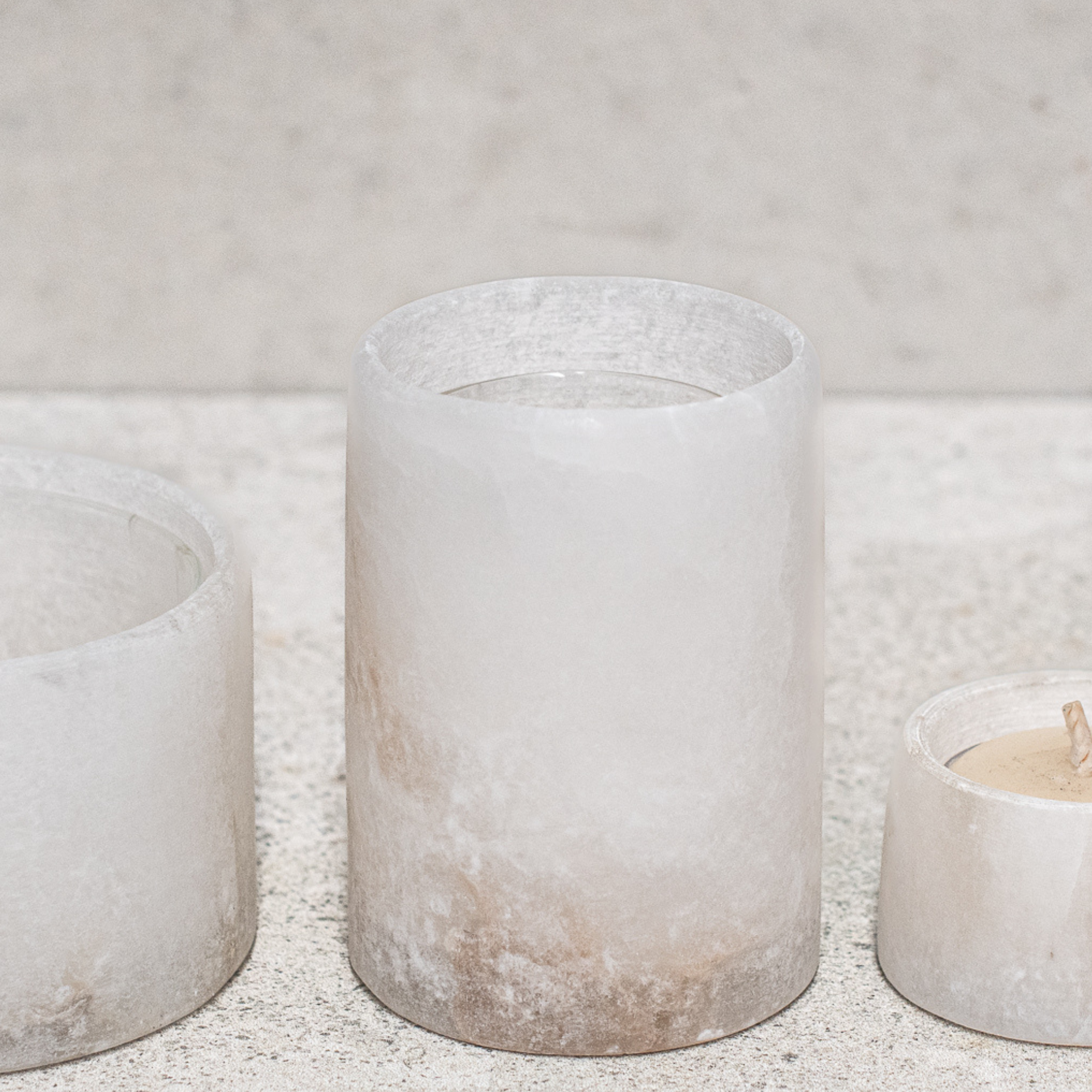 Set of alabaster votives, featuring a smooth, translucent design that gently diffuses light for a warm, ambient glow