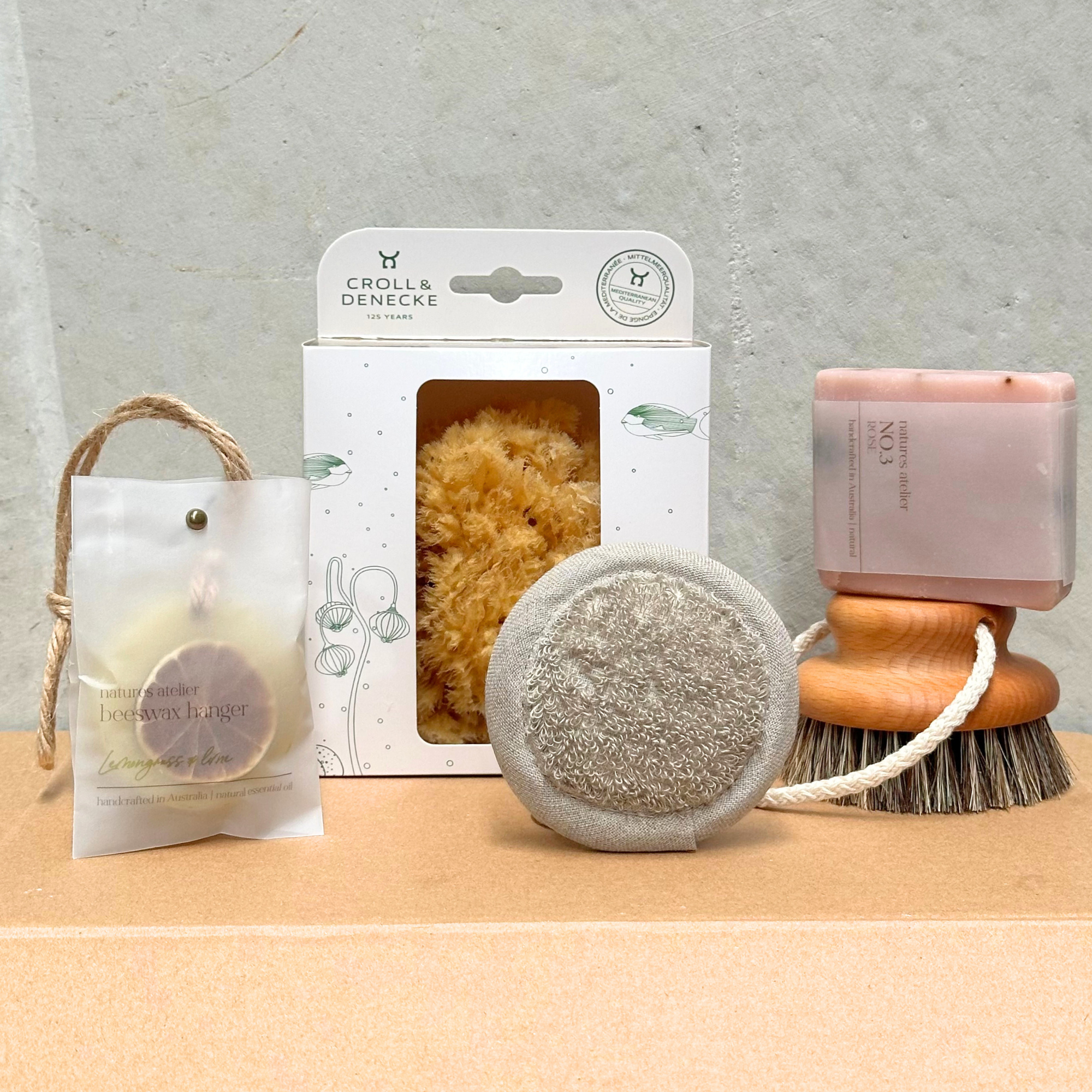 Heaven in Earth pamper gift box ($100), a luxurious set designed for relaxation and self-care, featuring a linen face sponge, beeswax hanger, massage hanging brush, handmade soap, and a sea sponge. This thoughtful collection provides everything needed for a soothing spa experience at home, perfect for unwinding and treating yourself or someone special