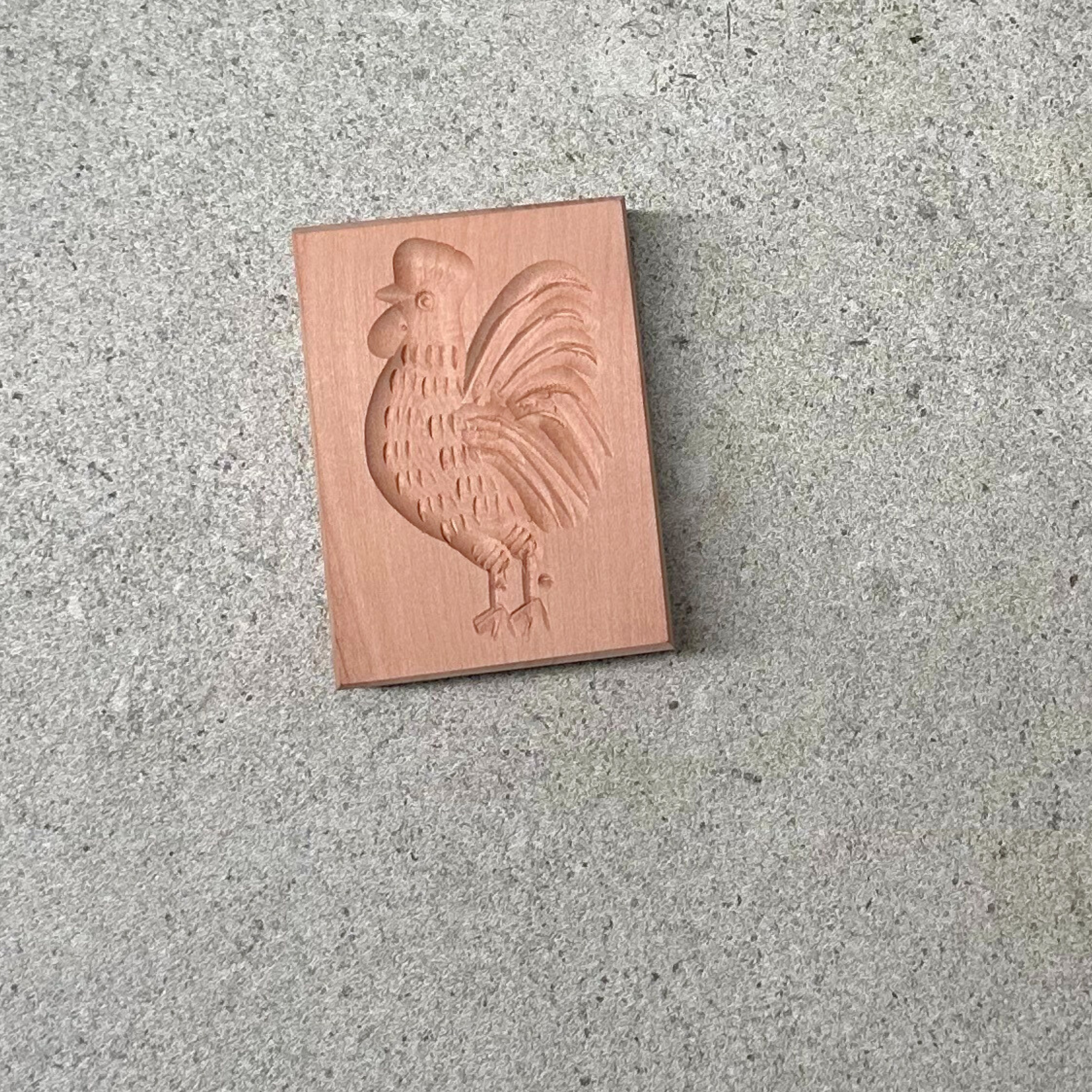 Wooden biscuit mould, intricately carved with detailed patterns, perfect for shaping traditional biscuits or cookies with a rustic, homemade touch