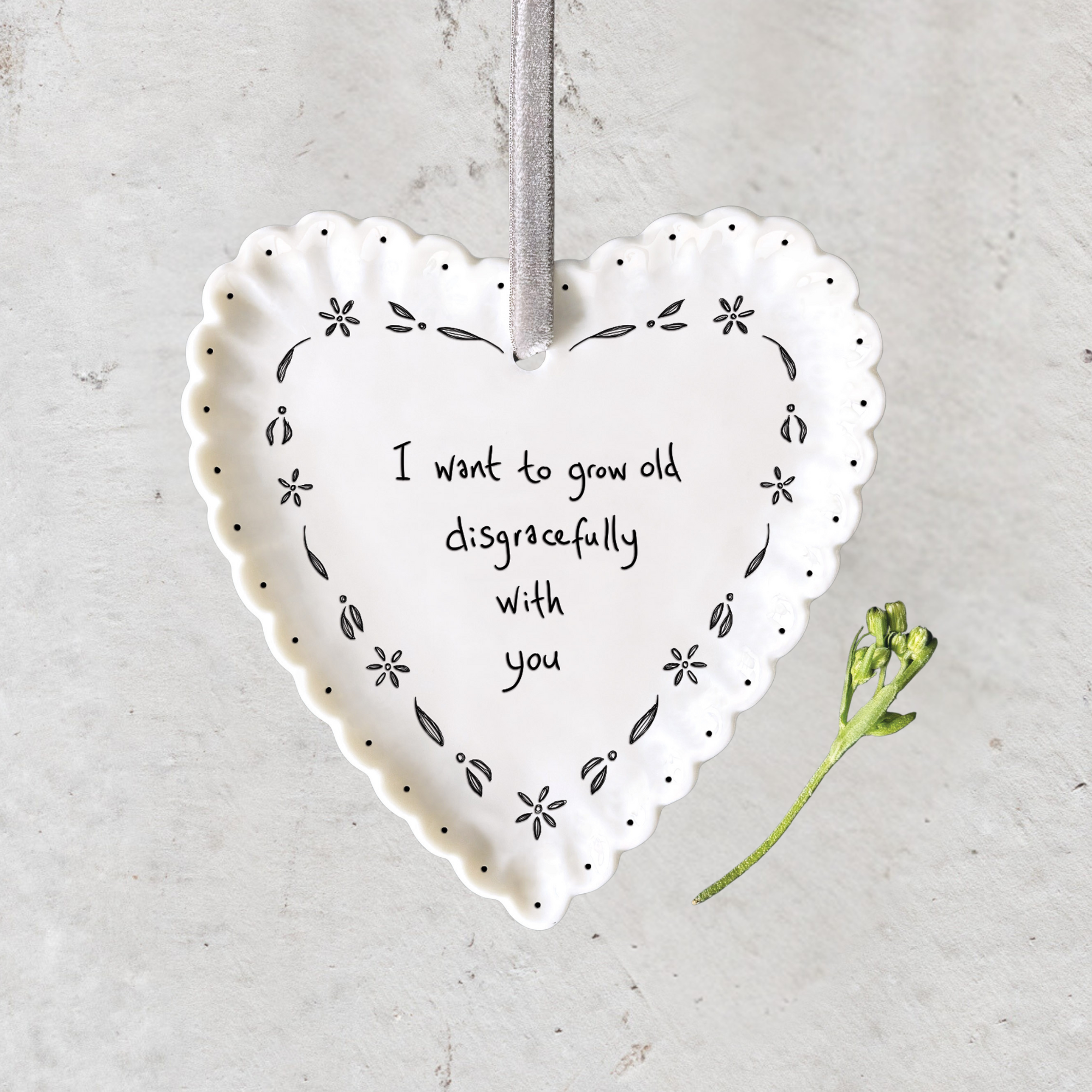 Handmade white porcelain heart hanger with scalloped edge, velvet ribbon and heartfelt sentiment by East of India.
