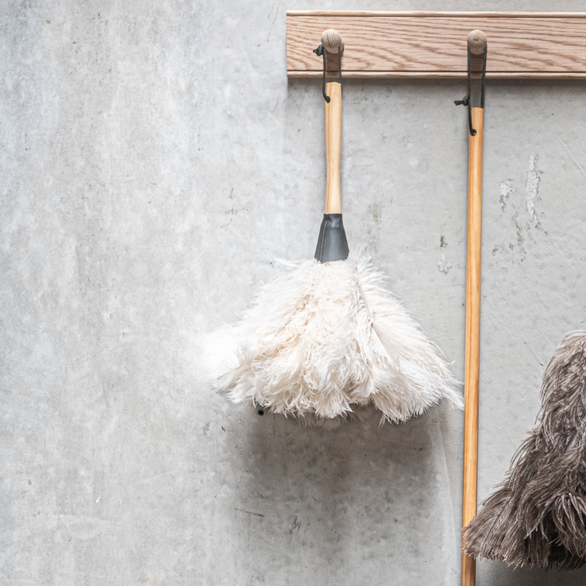 South African-made ostrich feather duster by Heaven in Earth (HIE), featuring soft, natural ostrich feathers that attract dust without spreading it. The lightweight wooden handle makes it easy to use, offering an elegant, eco-friendly solution for gentle, effective cleaning