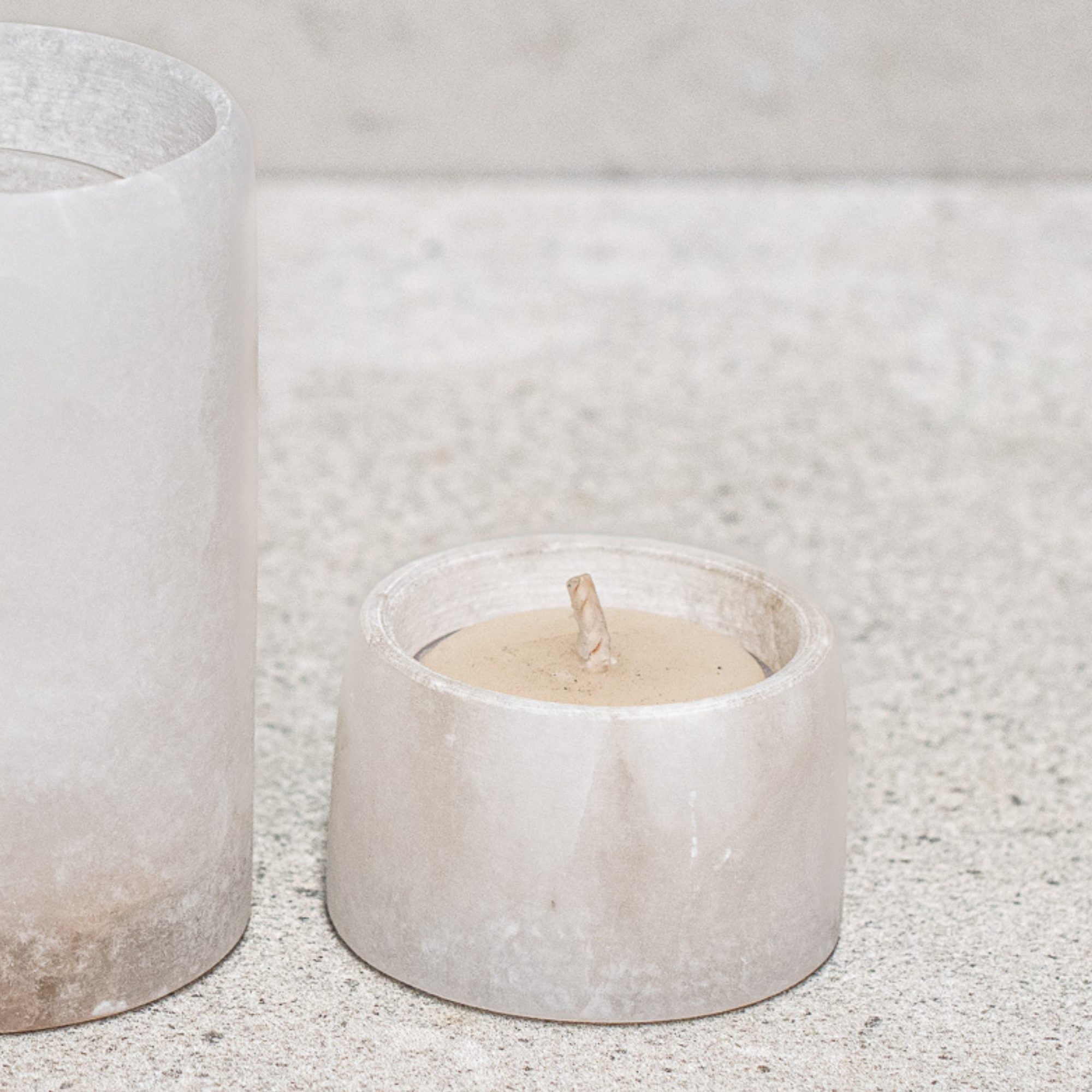 Set of alabaster votives, featuring a smooth, translucent design that gently diffuses light for a warm, ambient glow