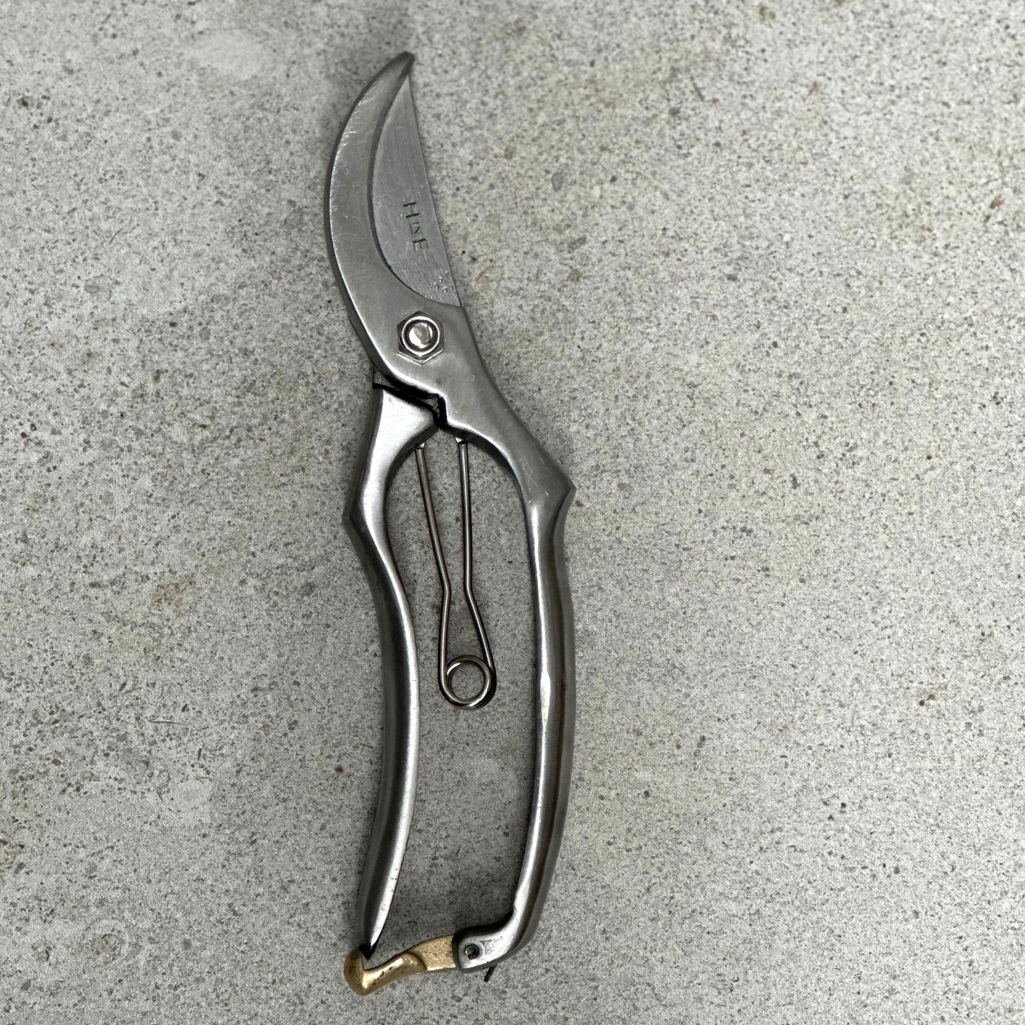 Engraved stainless steel garden secateurs handle detail