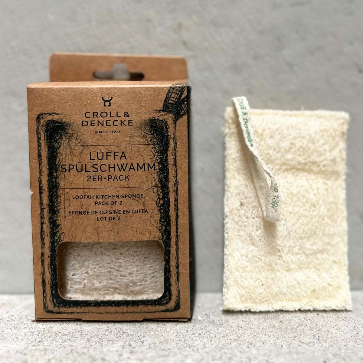 Pack of two natural loofah kitchen sponges made from plant fibres with plastic-free packaging by Croll & Denecke Germany.