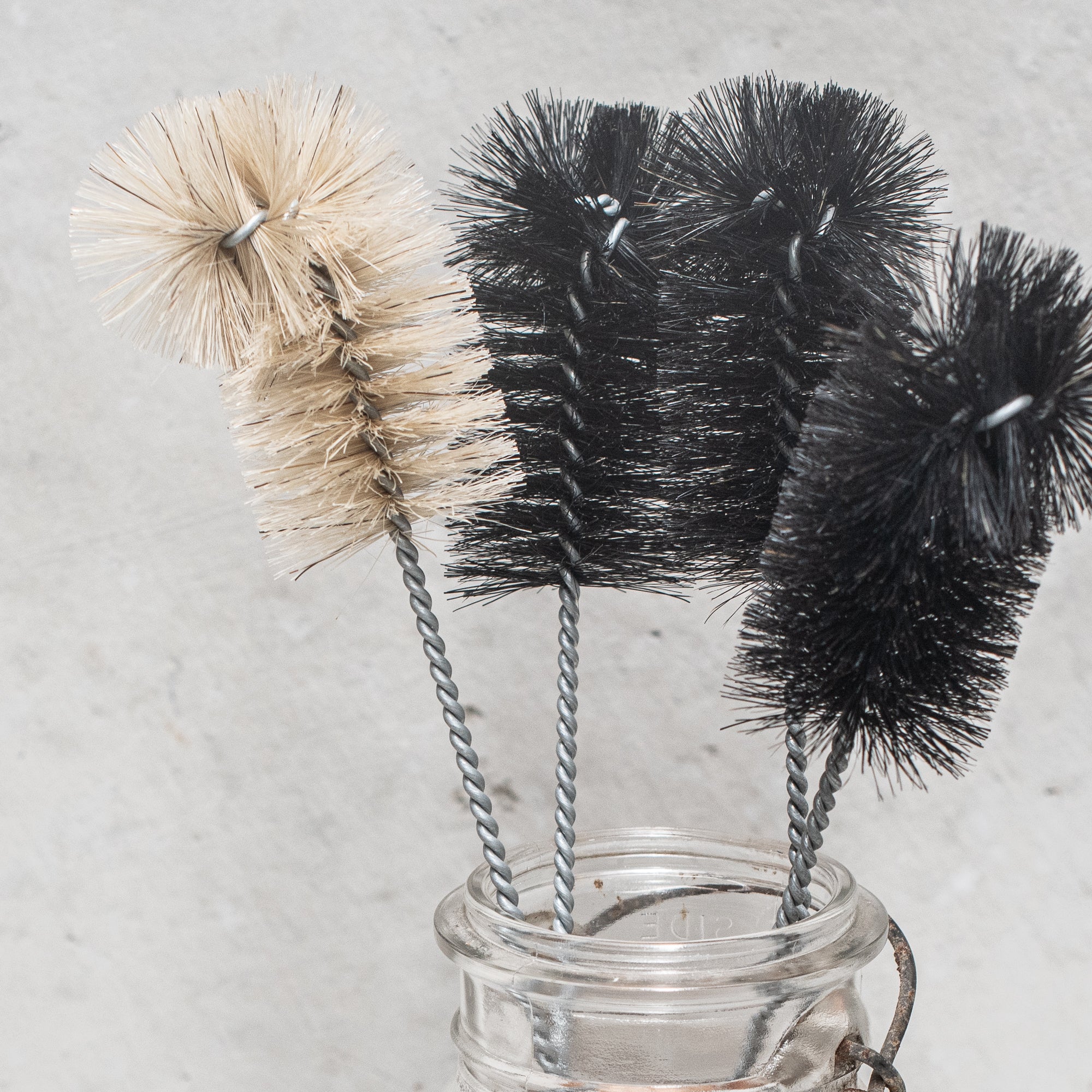 German-made bottle brush with natural fibre bristles light and dark, and a sturdy wooden handle, designed for thorough cleaning of bottles and jars, offering durability and eco-friendly craftsmanship