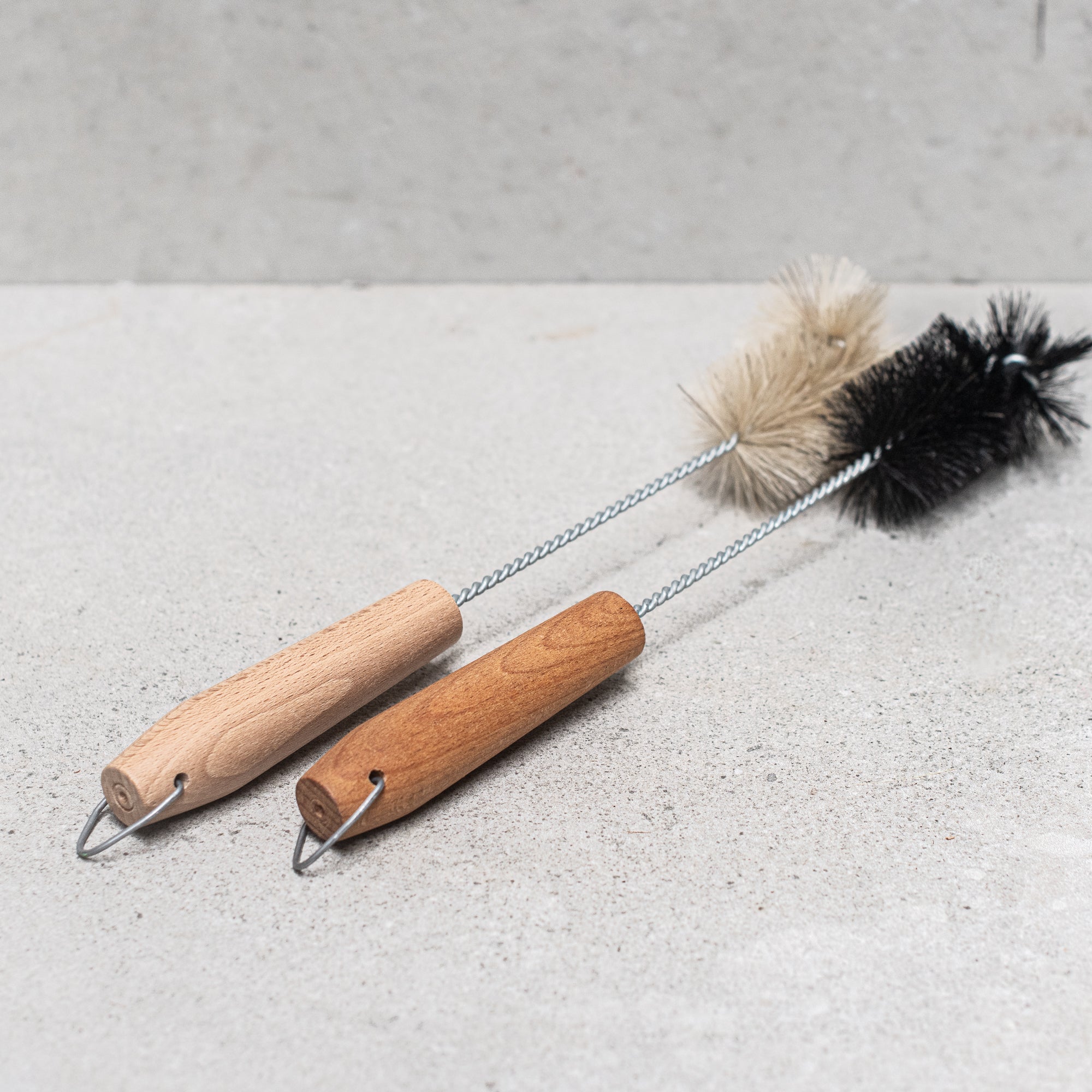 German-made bottle brush with natural fibre bristles light and dark, and a sturdy wooden handle, designed for thorough cleaning of bottles and jars, offering durability and eco-friendly craftsmanship