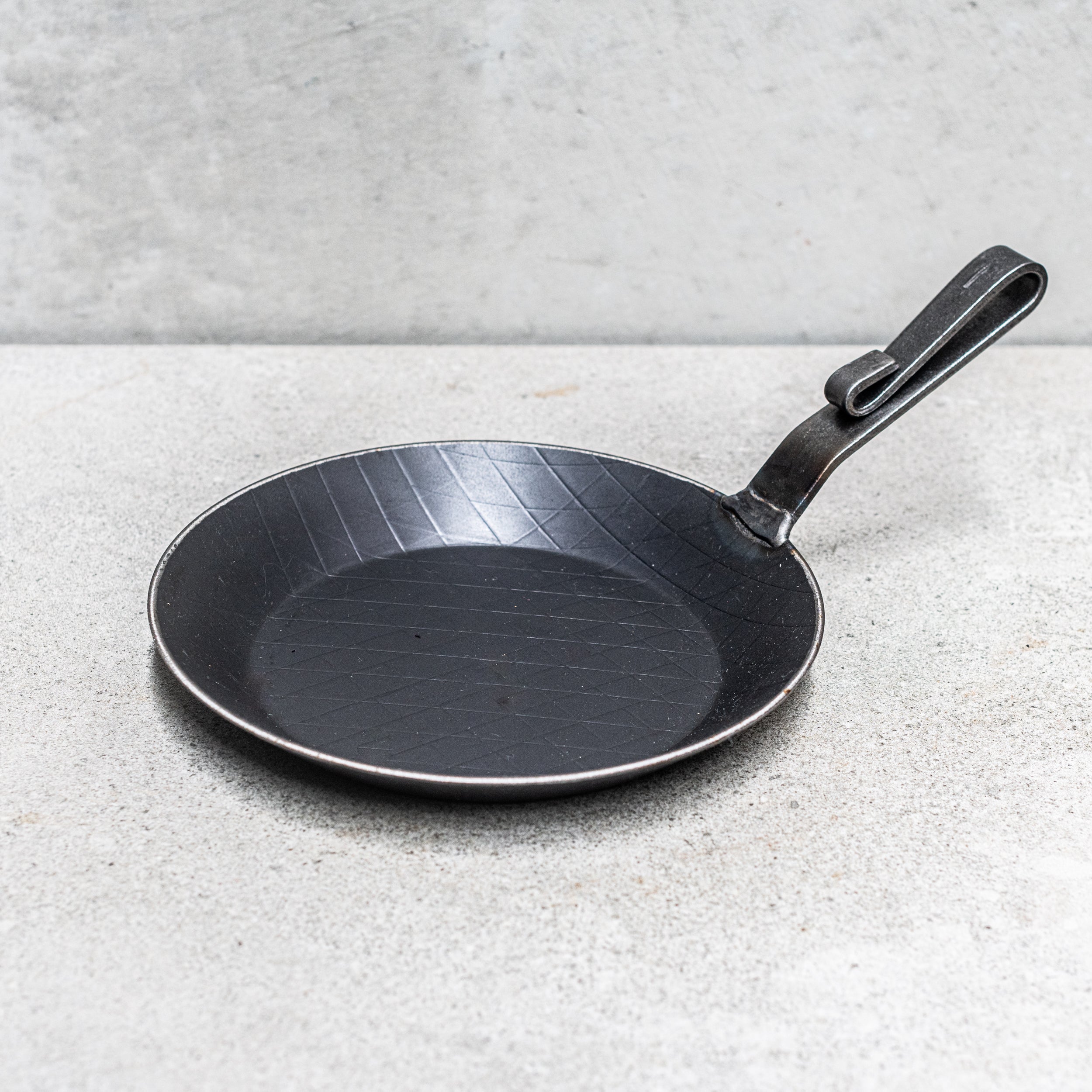 Heaven in Earth (HIE) German-made chemical-free forged iron frying pan, crafted with traditional techniques for durability and even heat distribution. Perfect for searing, frying, and sautéing, this eco-friendly pan ensures a safe, natural cooking experience without any harmful chemicals