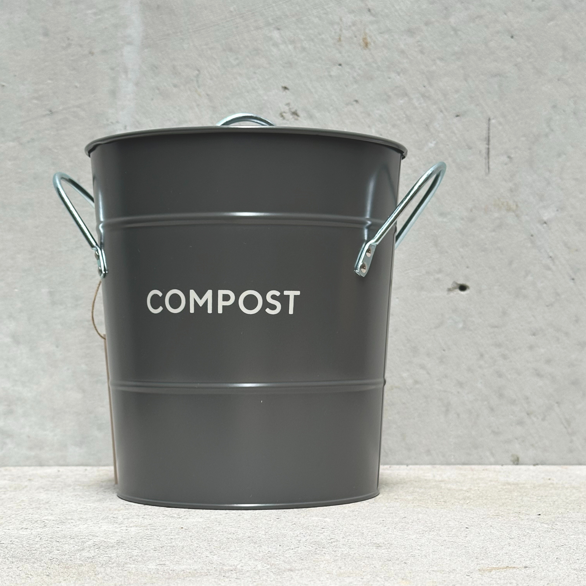 Heaven in Earth metal compost bin, featuring a sleek, durable design perfect for collecting kitchen scraps and creating nutrient-rich compost.