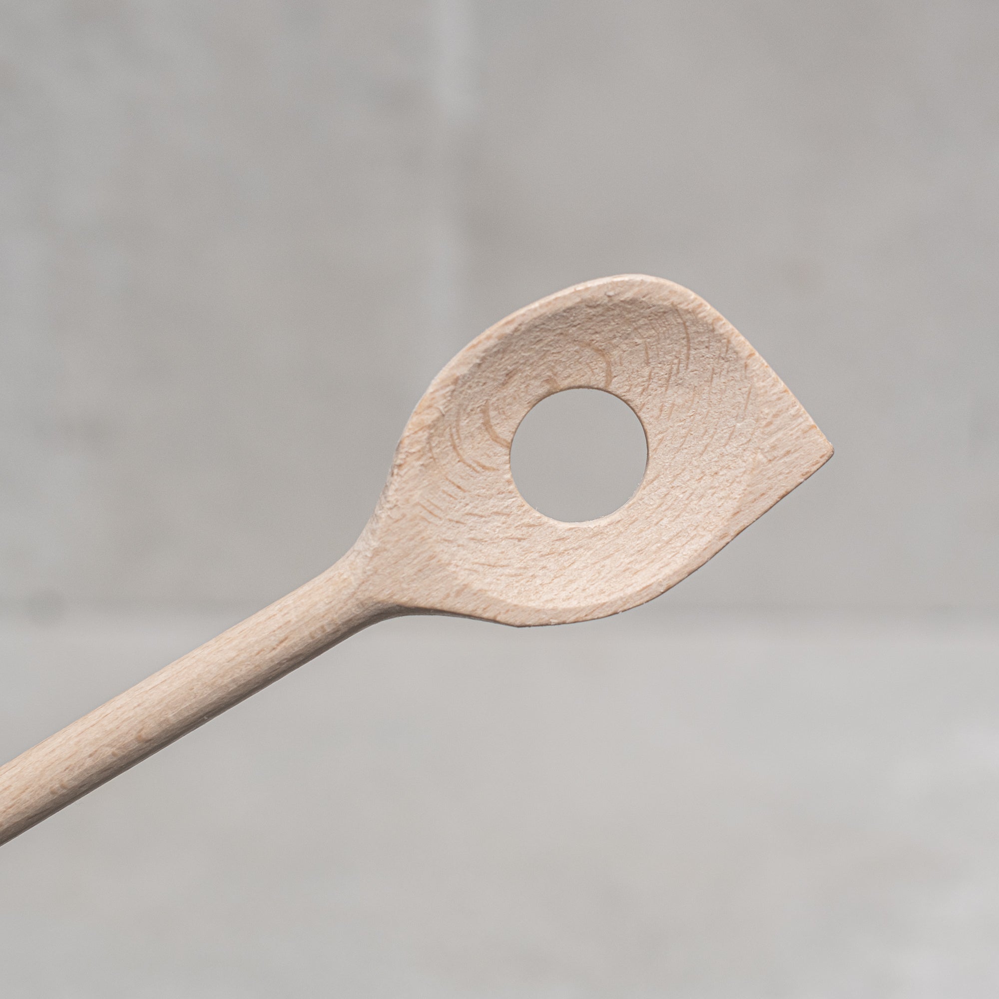 Scraper spoon with hole heaven in earth