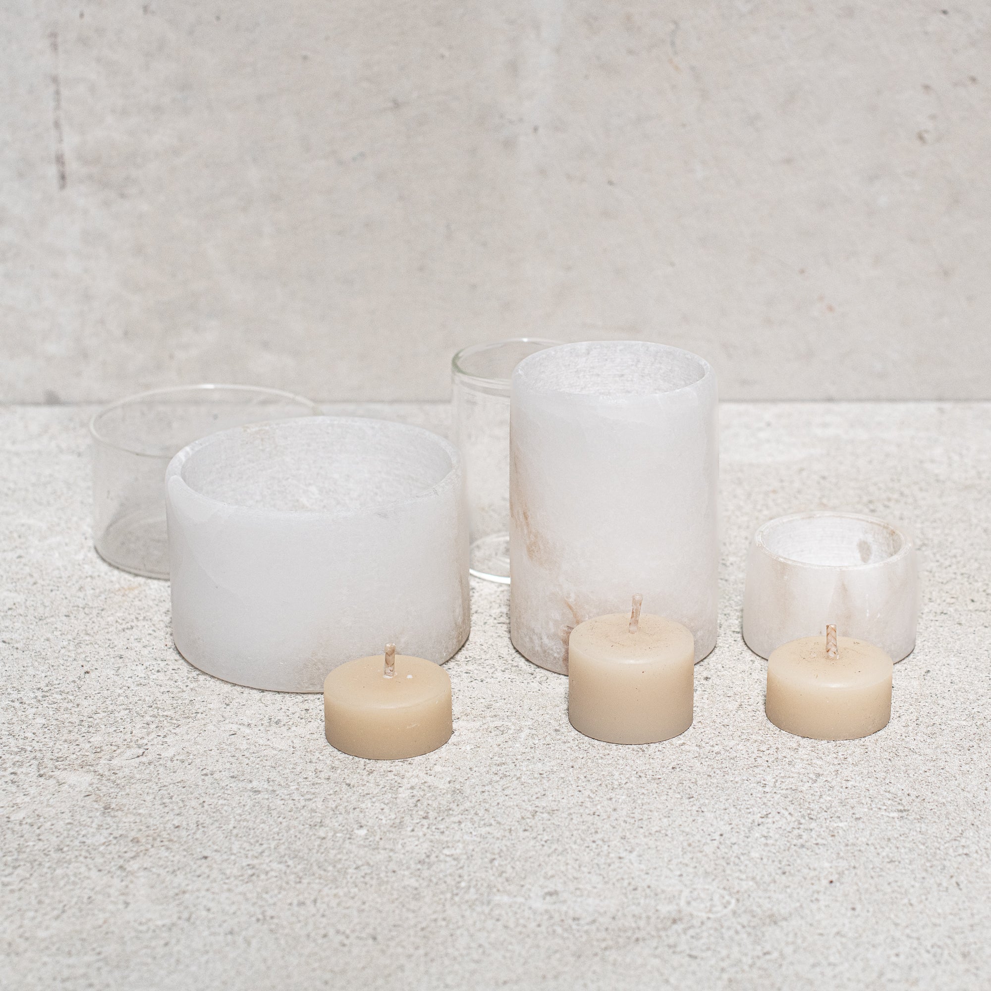 Set of alabaster votives, featuring a smooth, translucent design that gently diffuses light for a warm, ambient glow