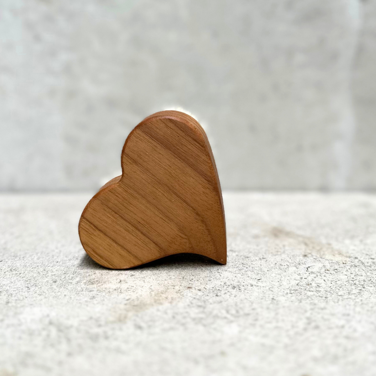 Heart-shaped baby hair brush with soft natural bristles and solid nutwood handle by Keller Bürsten Germany.