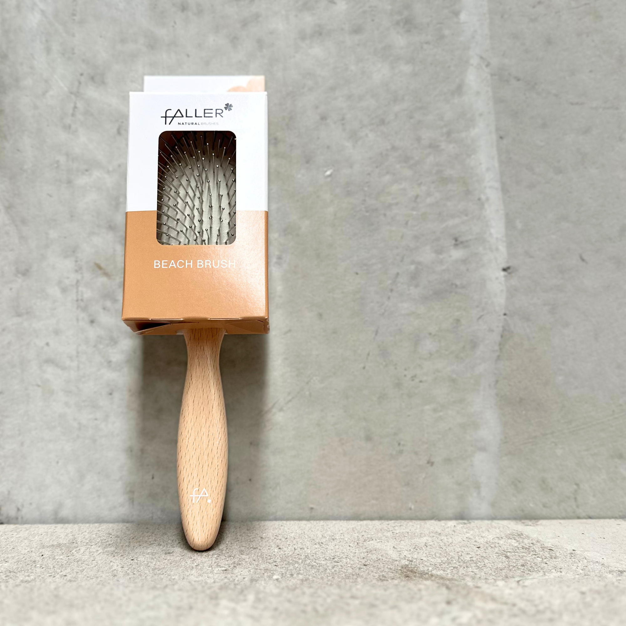 Beach and pool hair brush with flexible steel pins and varnished beechwood handle by Faller Germany.
