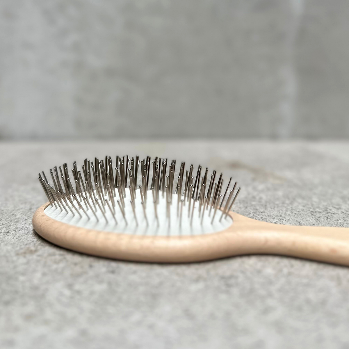 Beach and pool hair brush with flexible steel pins and varnished beechwood handle by Faller Germany.