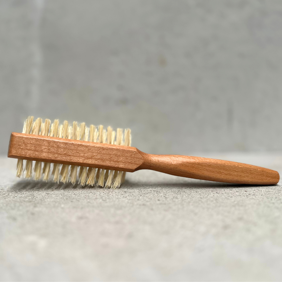 Half round vegan hair brush with beechwood handle and vegan fibre bristles by Faller Germany.