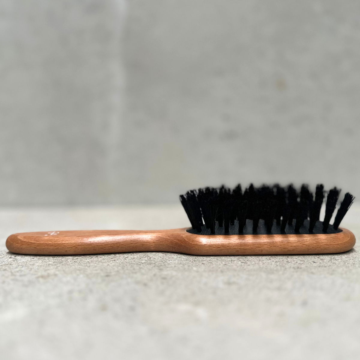 Long natural bristle hair brush with beechwood handle for fine hair by Faller Germany.